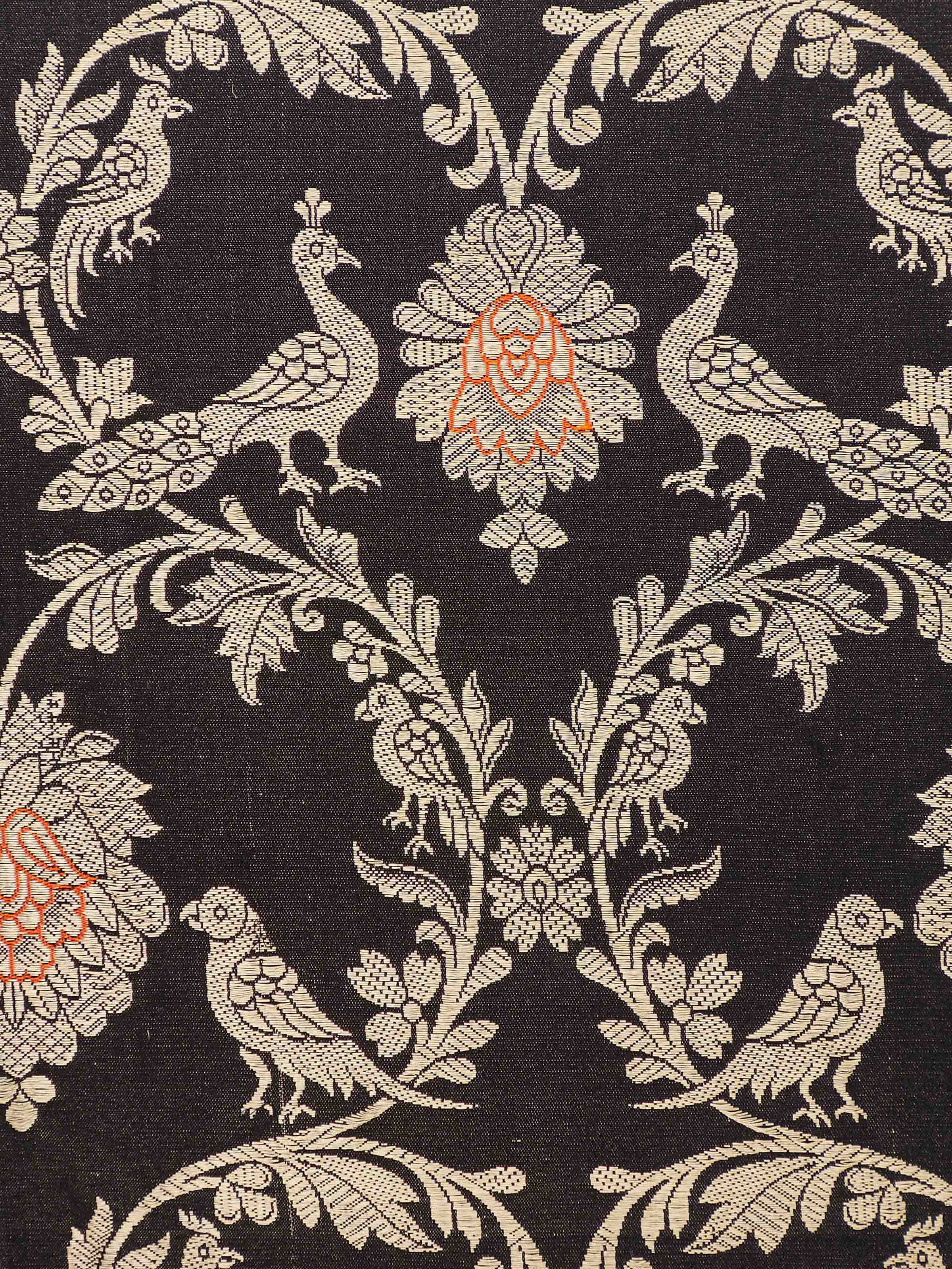 Close-up shot of Banarasi weave detailing on black silk cushion cover