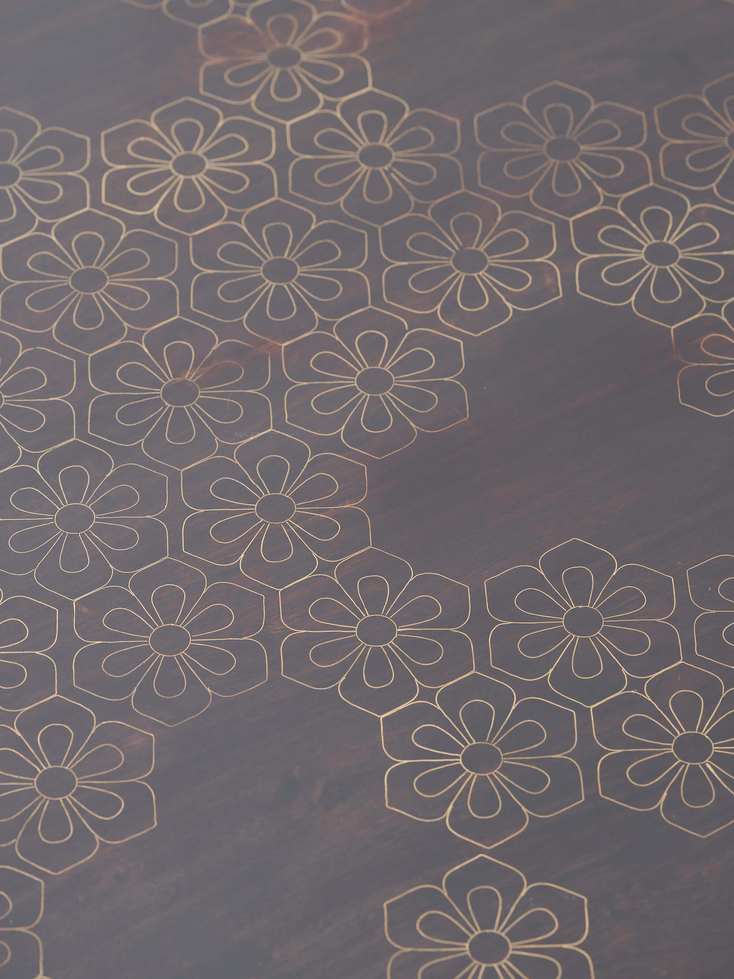 Angled view of the Sheesham wood coffee table with visible brass inlay work, illustrating its elegant design
