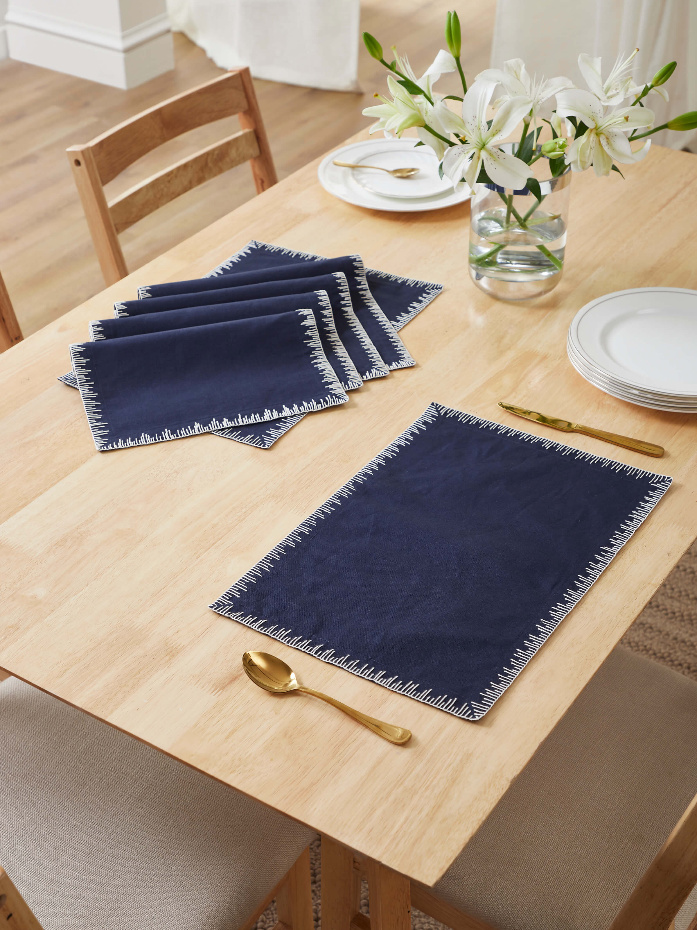 Indigo edge stitch hand embroidered table mats placed on dining table – set of 6