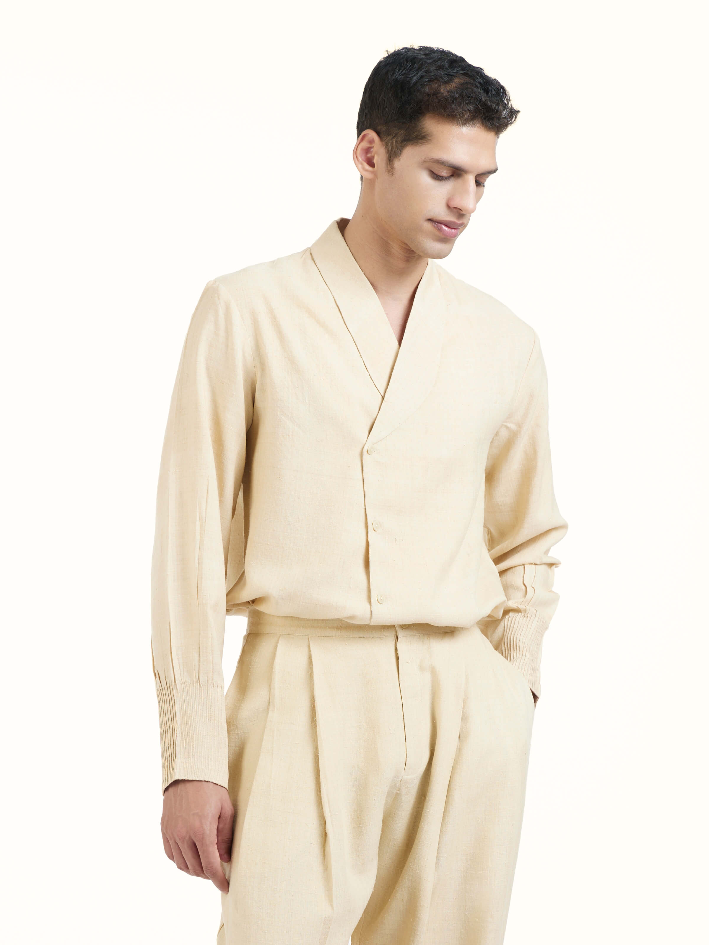 Angled view of off-white silk handloom straight pants highlighting fabric texture