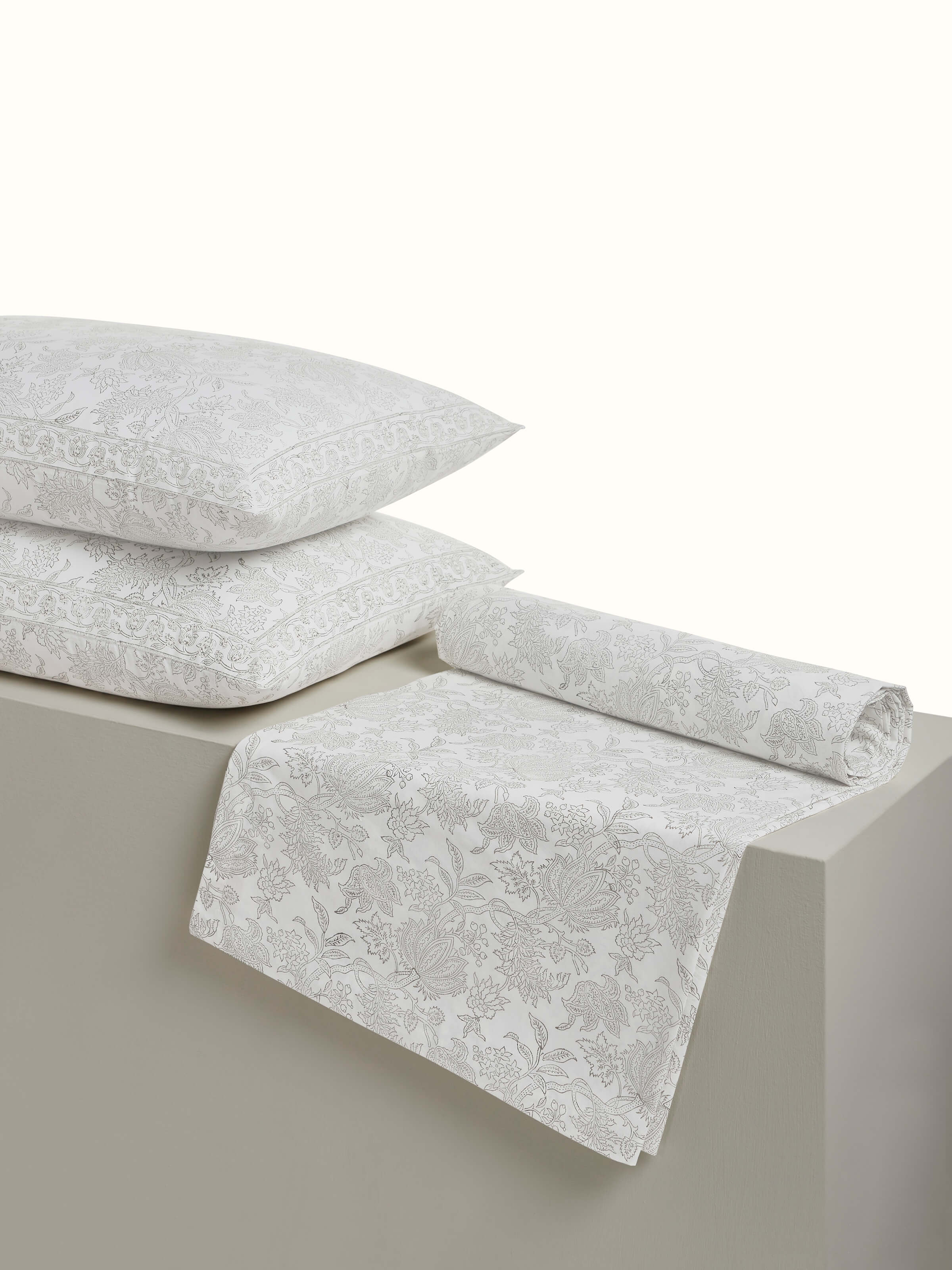 Angled view of grey floral Sanganeri cotton bedsheet showcasing full bedspread layout