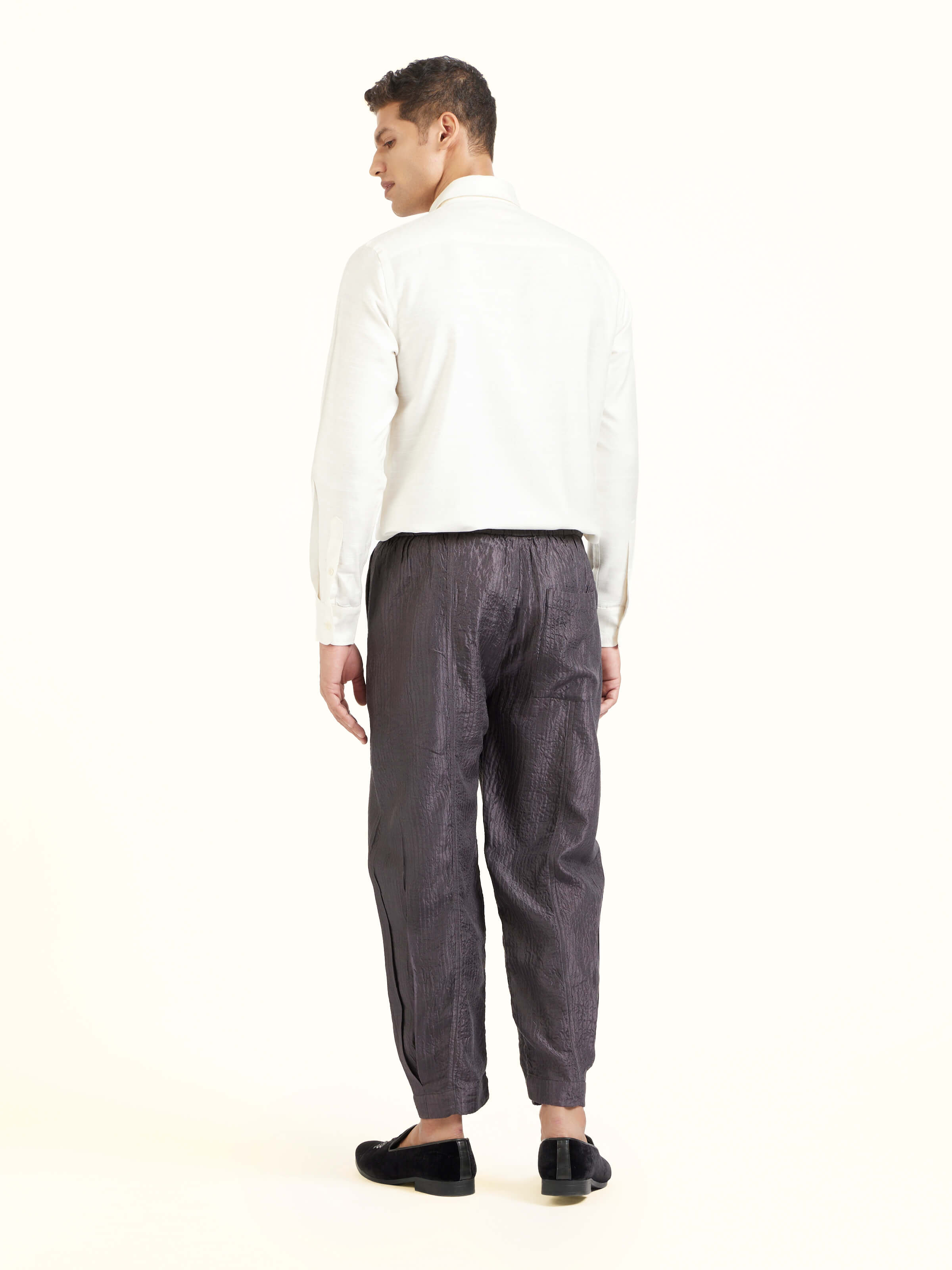 Back view of grey straight quilted tulip pure silk pants displaying overall design