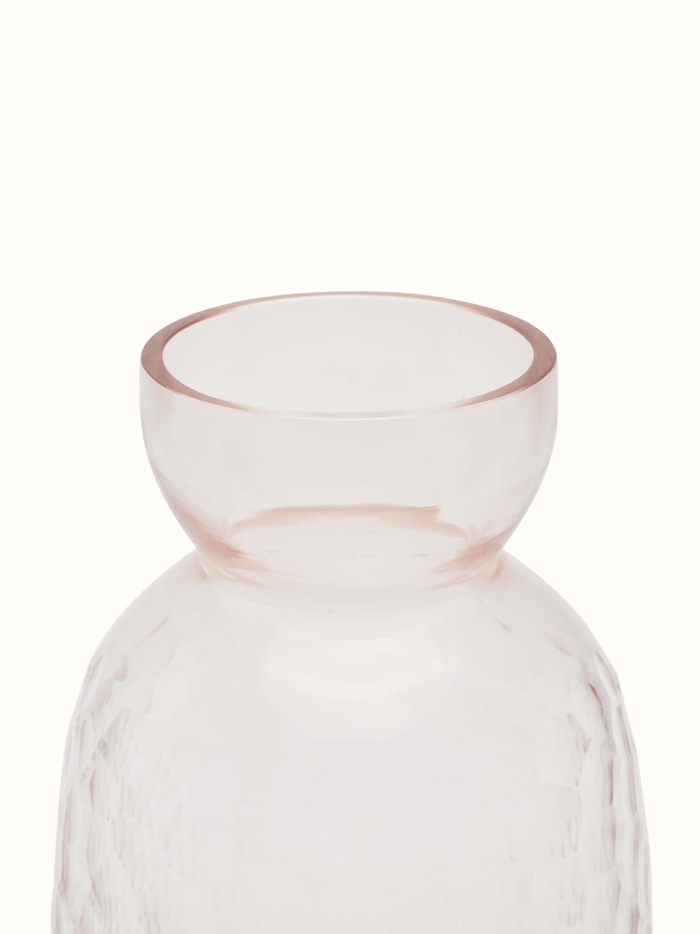 Close-up view of glass table vase in peach color, emphasizing the color depth and clarity.