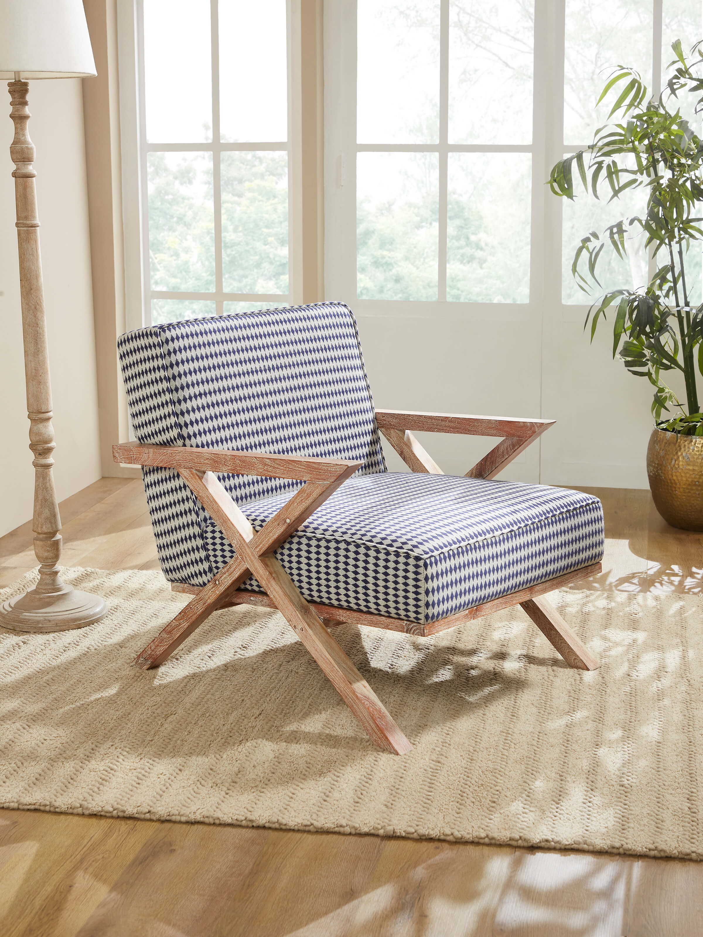 Side view of Swadesh Upholstered Acacia Wood Armchair highlighting its smooth wooden legs and stylish armrest design