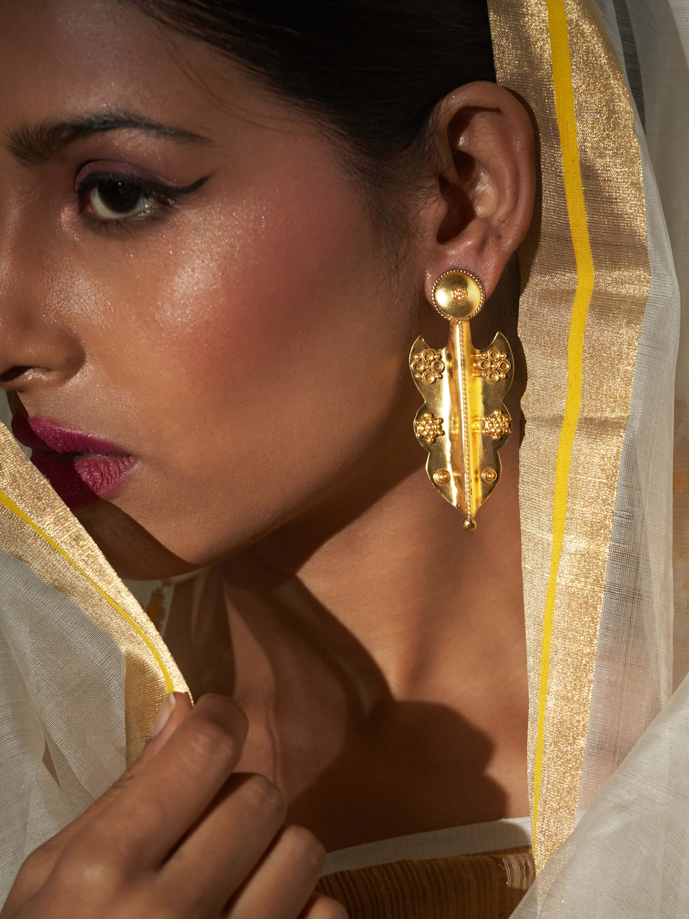 Side view of Silver Smithing Drop Earrings showing detailed silverwork and design.