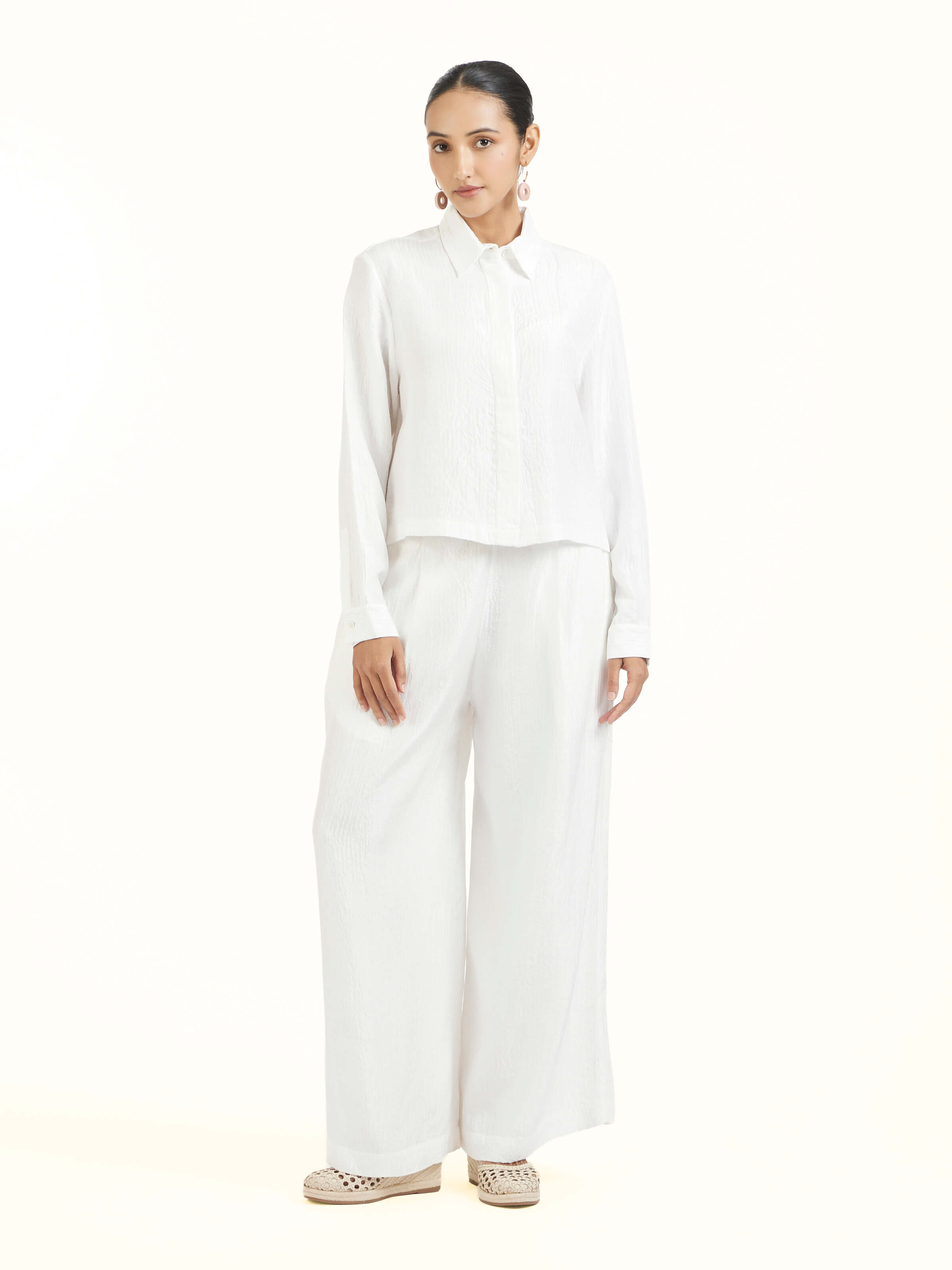 Front view of ivory quilted silk pants with elegant stitching