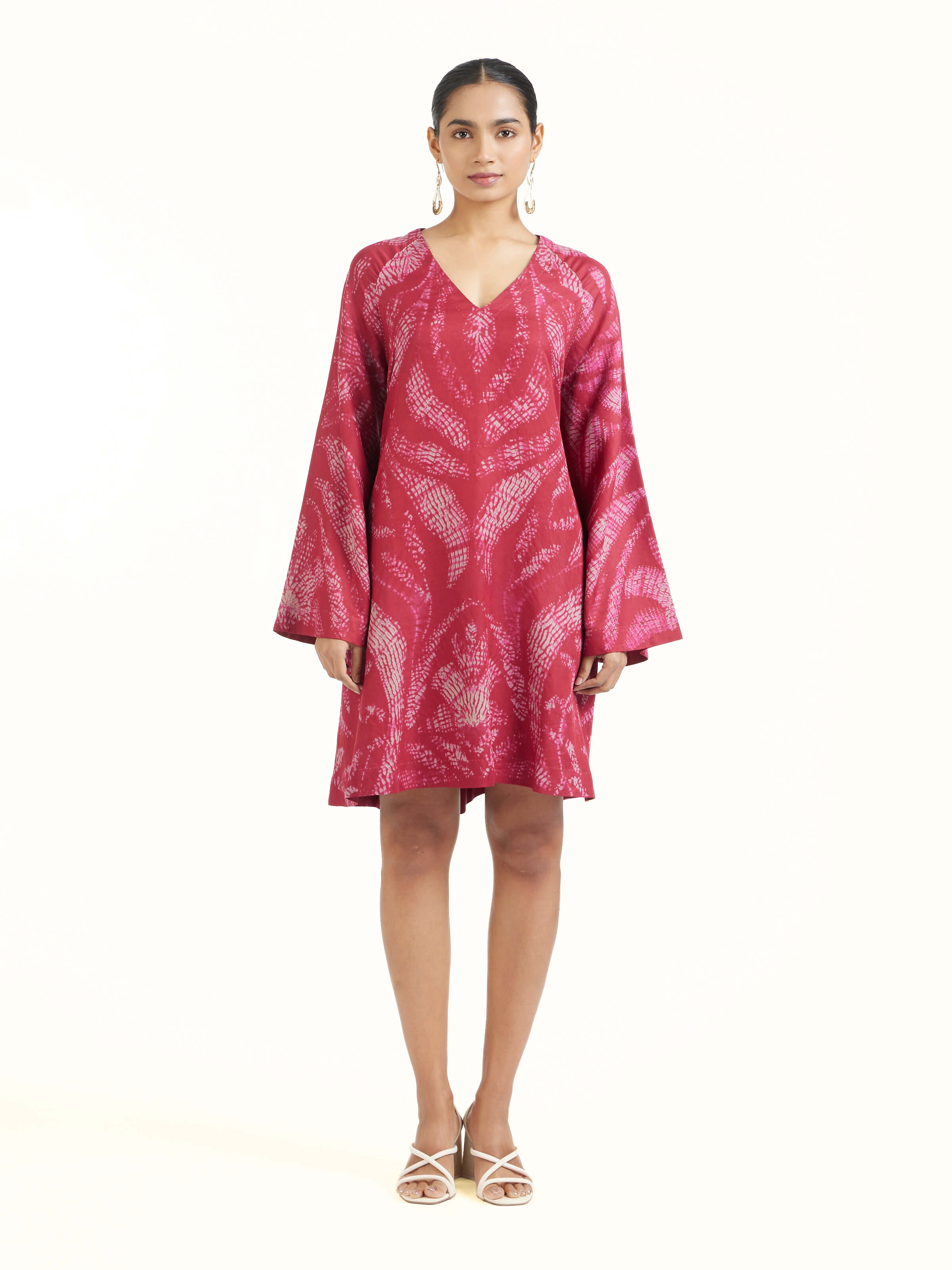 Front view of red silk Shibori dress highlighting vibrant shibori patterns