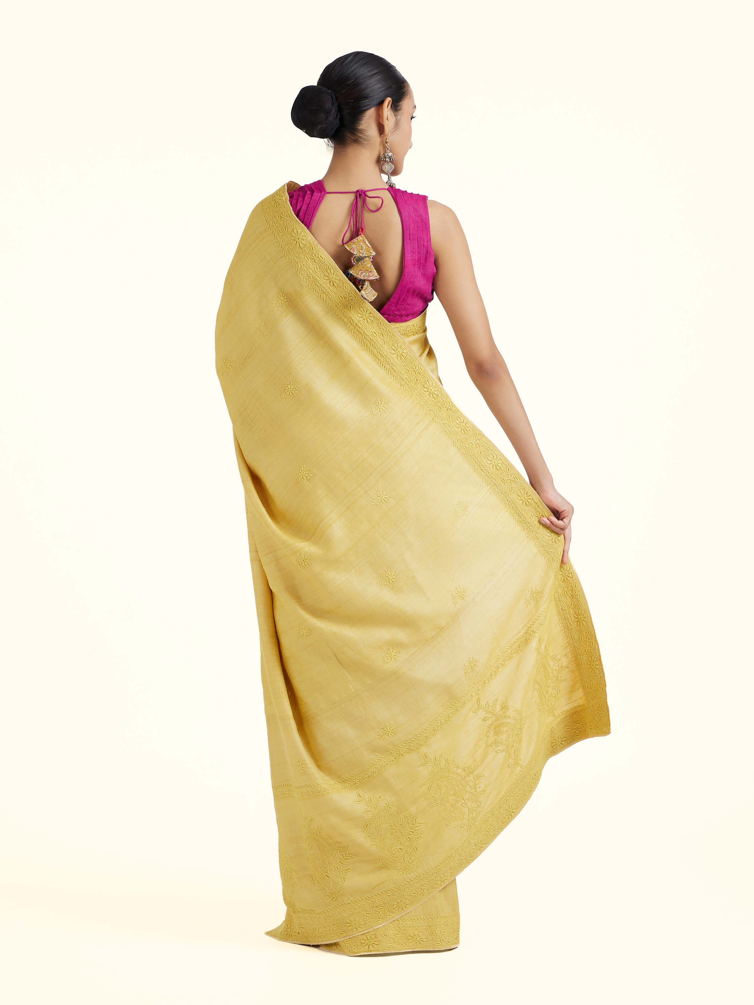 Back view of yellow silk Chikankari saree displaying full pallu design