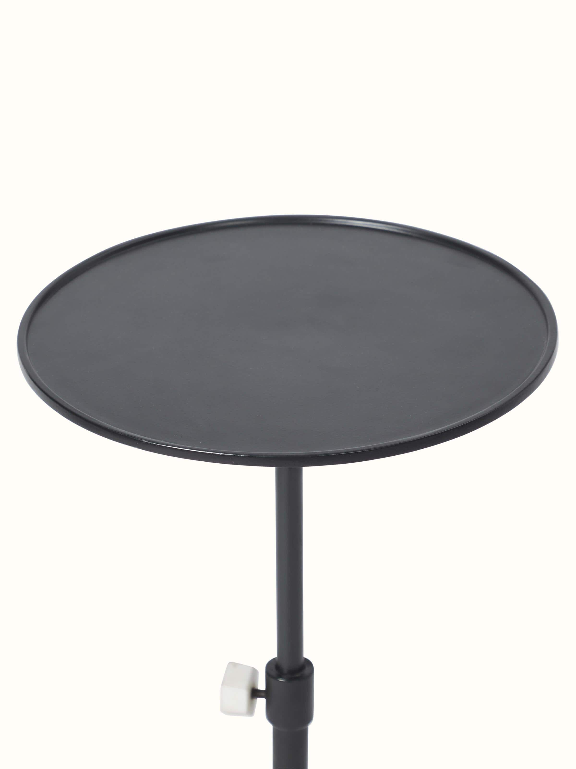 Side view of carved marble & metal end & side table highlighting elegant craftsmanship