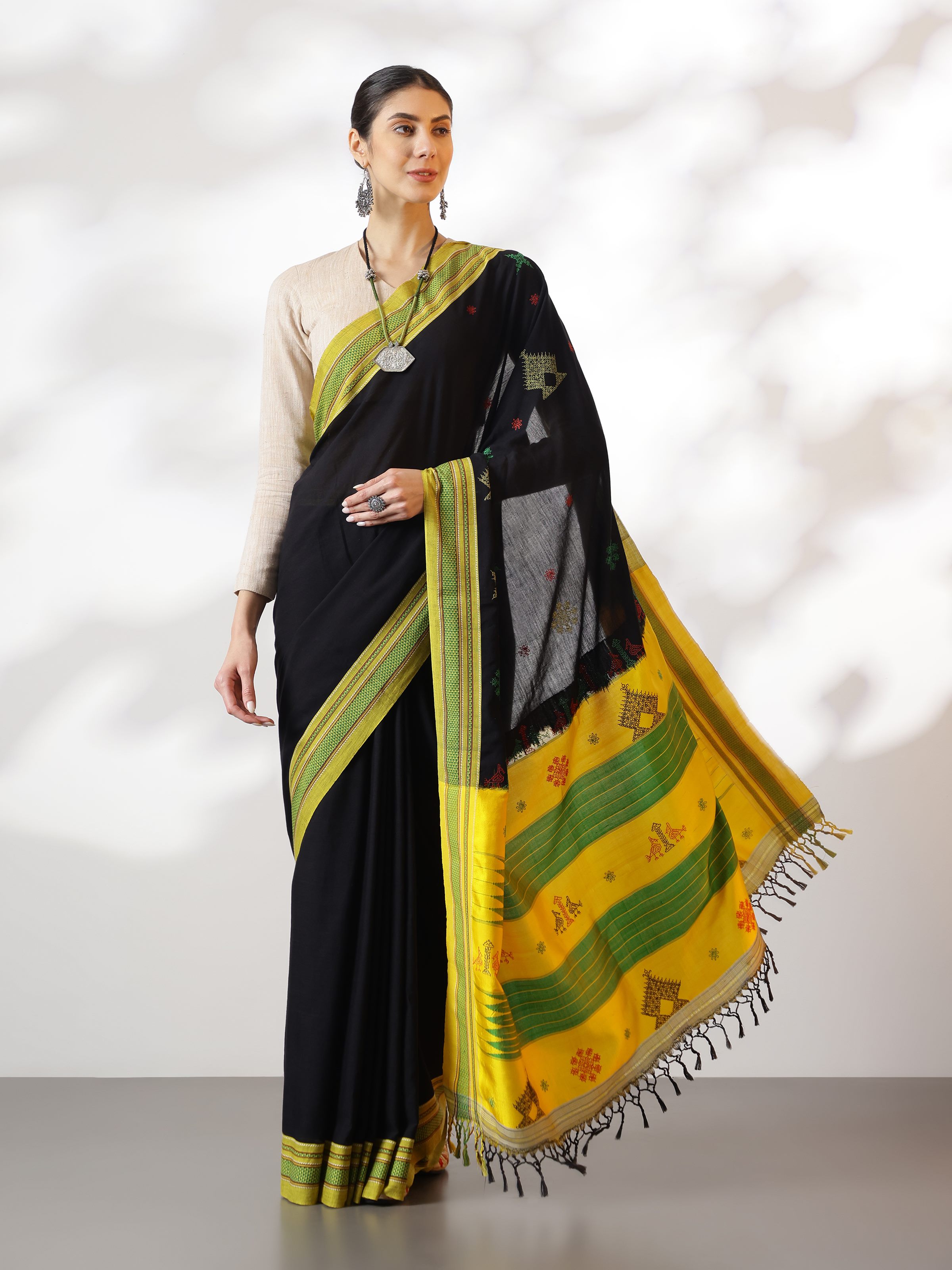 Side view of black cotton silk Kasuti embroidered saree with elegant drape and border