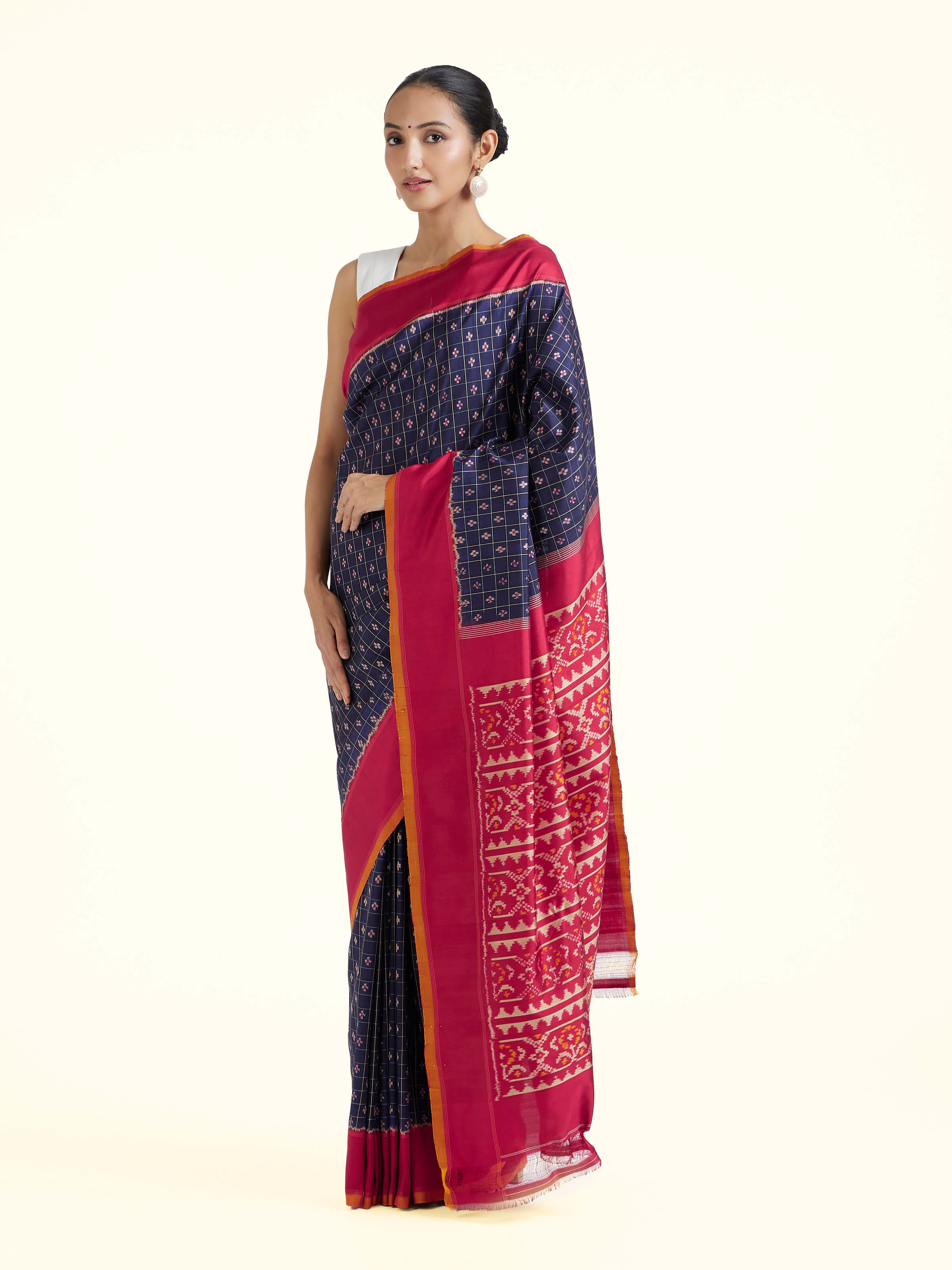 Side view of navy mulberry silk Ikat saree highlighting fluid drape and woven detailing