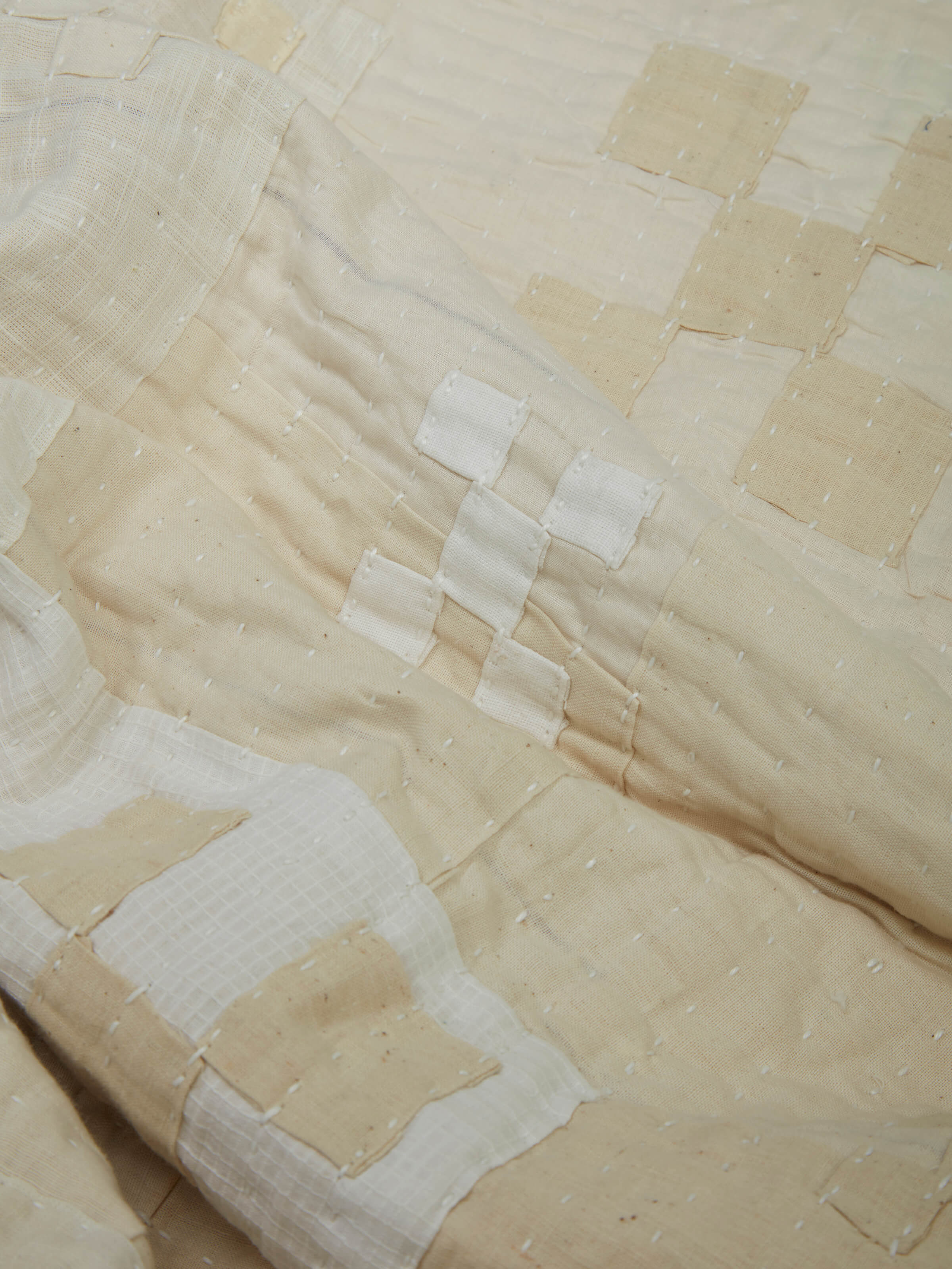 Detailed fabric and stitch work on Siddi abstract patchwork bedspread