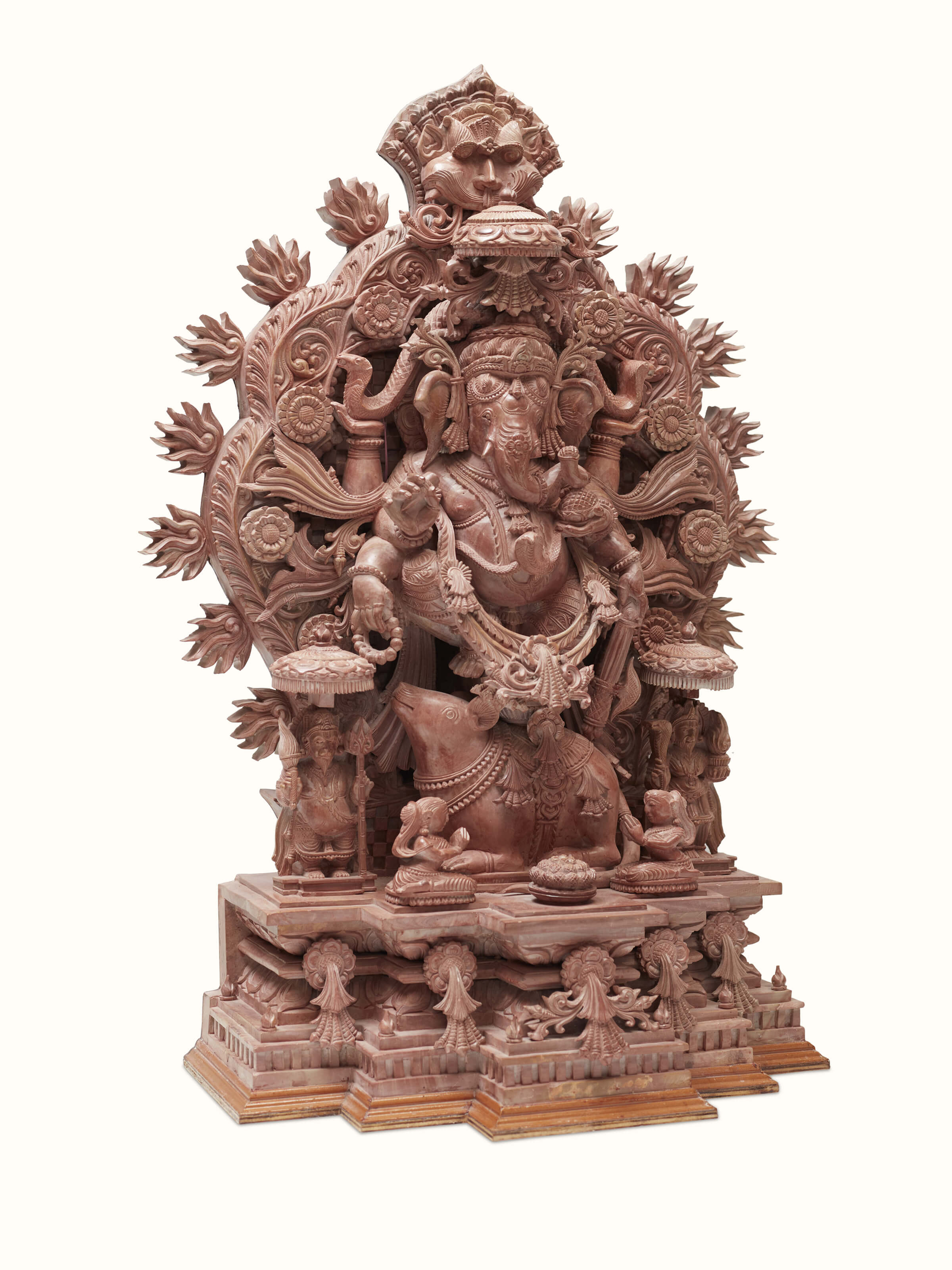Side view of carved stone Vinayaka idol, showcasing the intricate stone work.