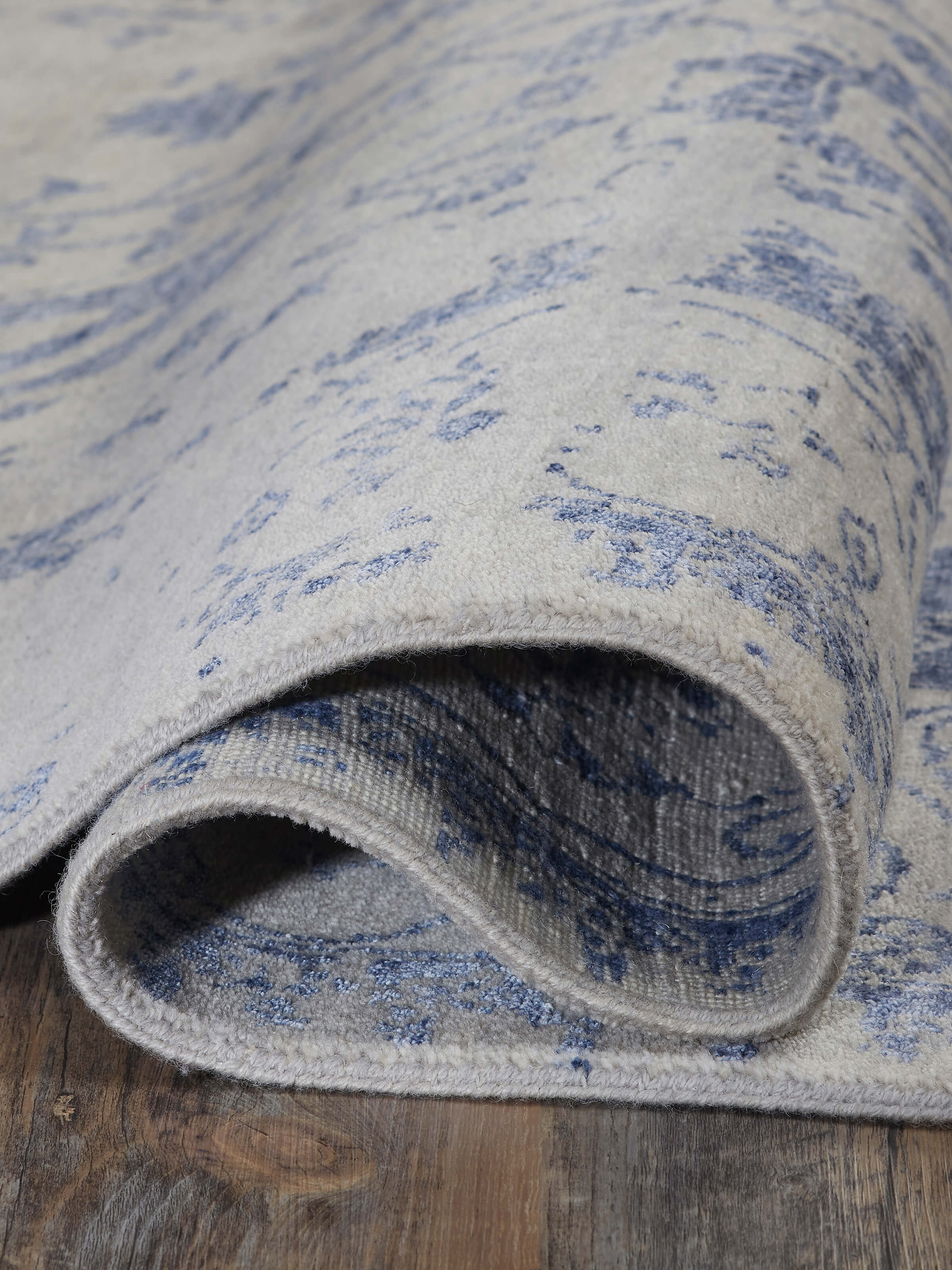 Close-up view of Distressed Transitional Grey Blue Agra wool & viscose hand-knotted rug highlighting the texture and detail