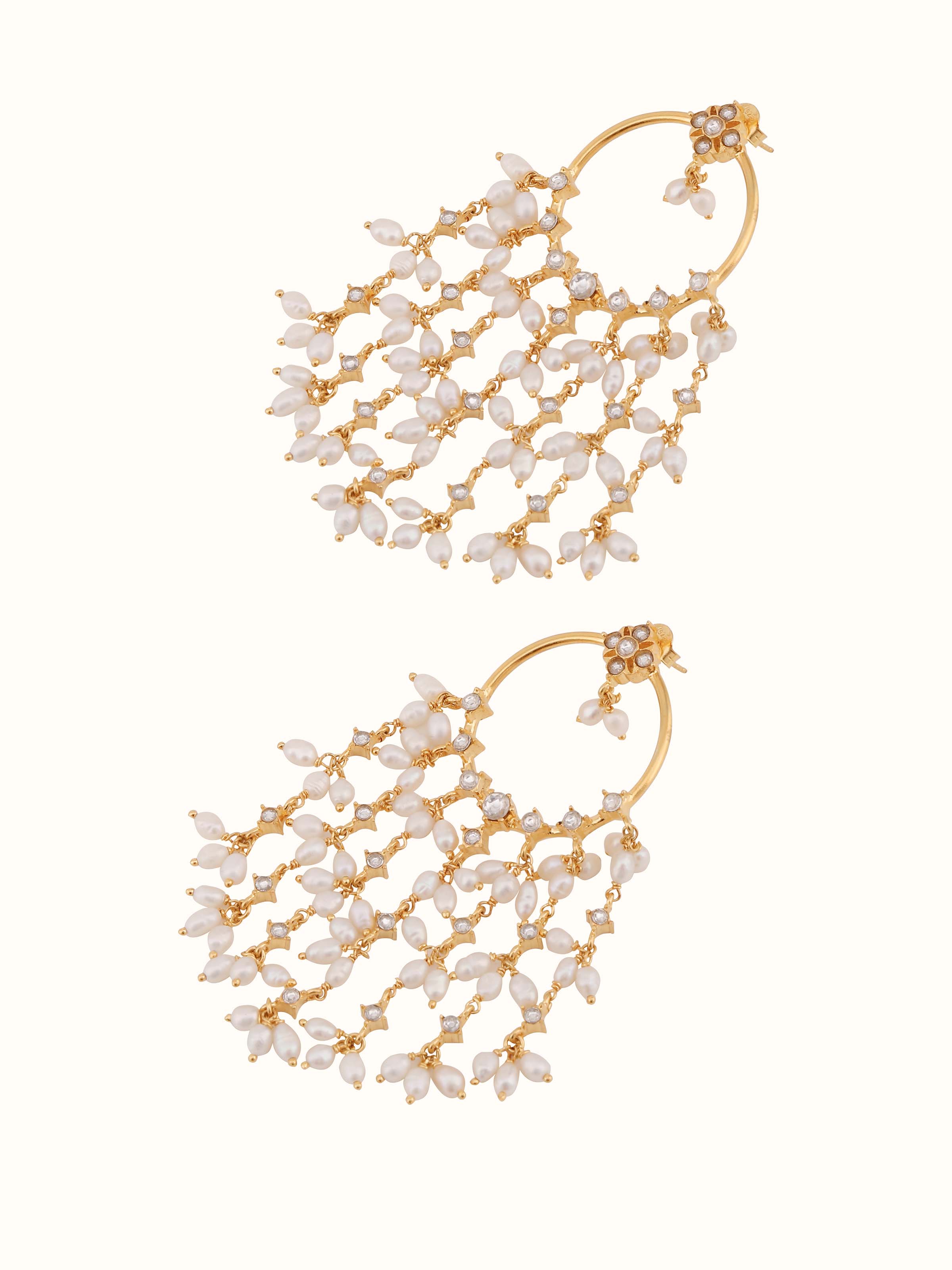 Detail shot focusing on the contrast between the oxidised silver and creamy white pearls in the earring design.