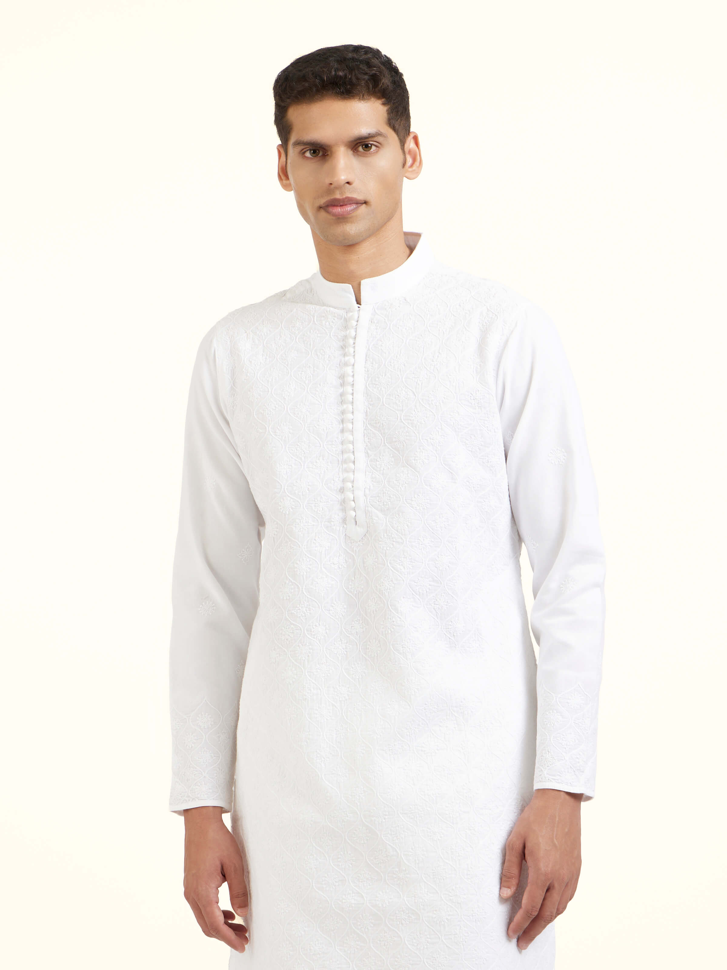 Angled view of white cotton chikankari long kurta highlighting chikankari work
