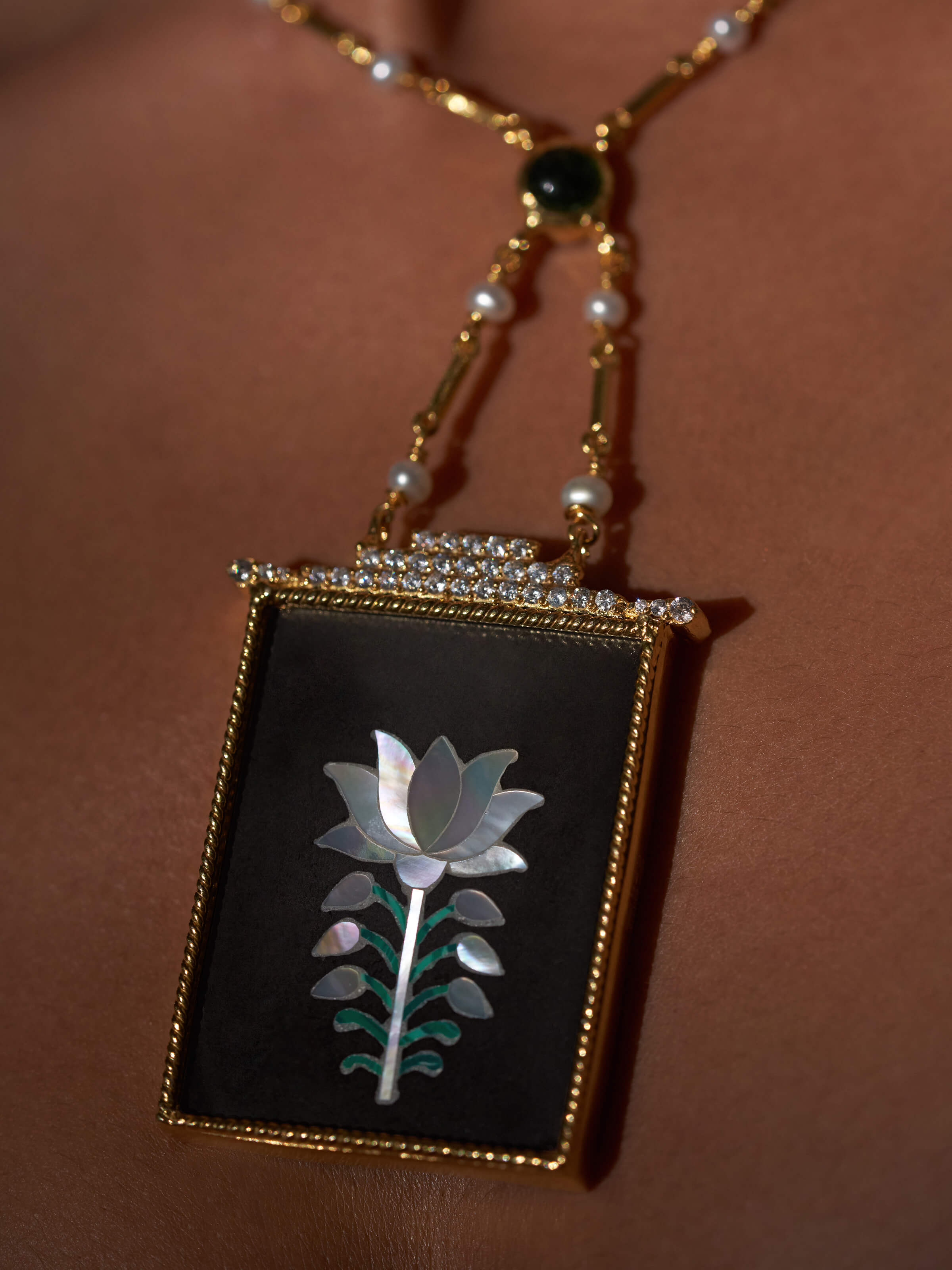 Artistic profile view highlighting fine silver detailing and pendant shape