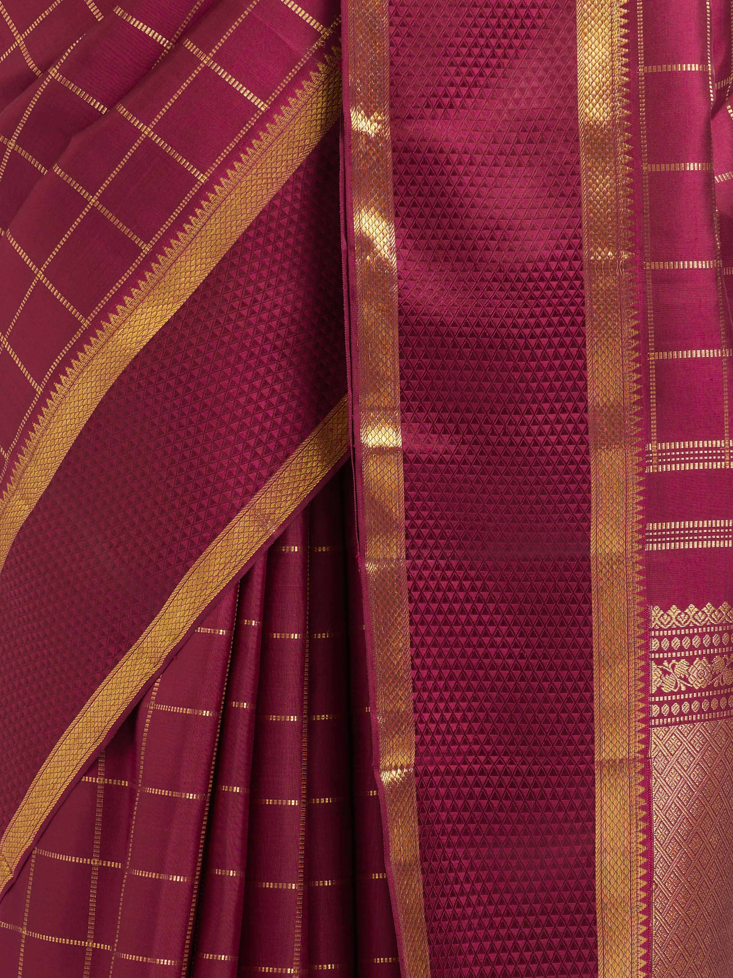 Detail view of burgundy silk Kancheepuram saree showing silk texture and zari craftsmanship