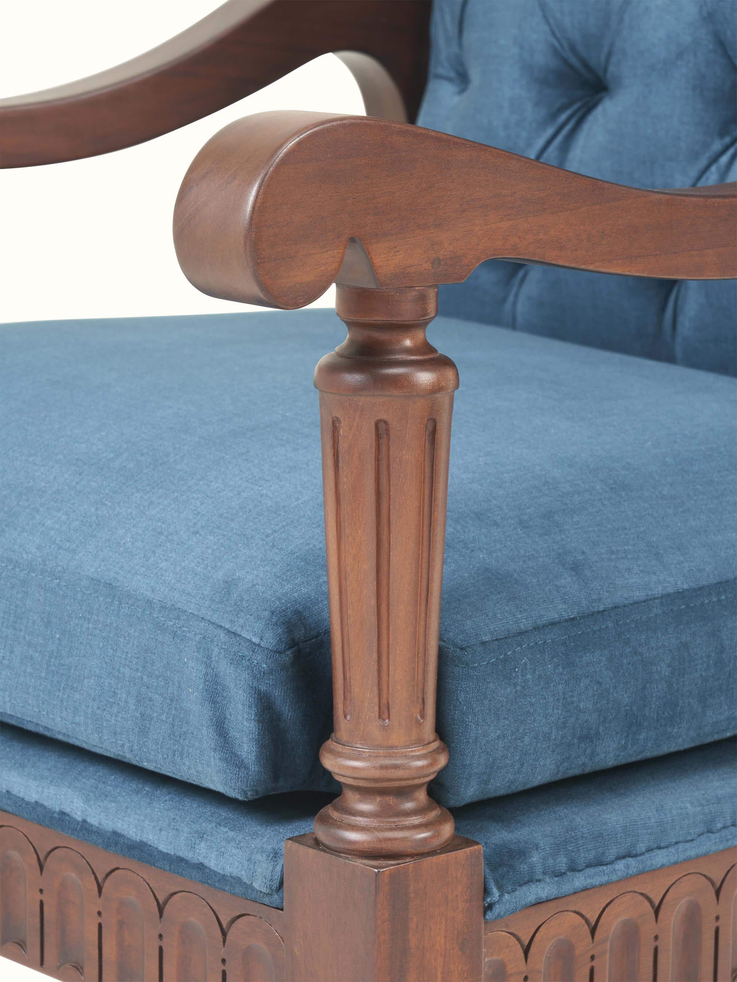 Detail shot of upholstered mahogany arm chair highlighting stitching and cushion design