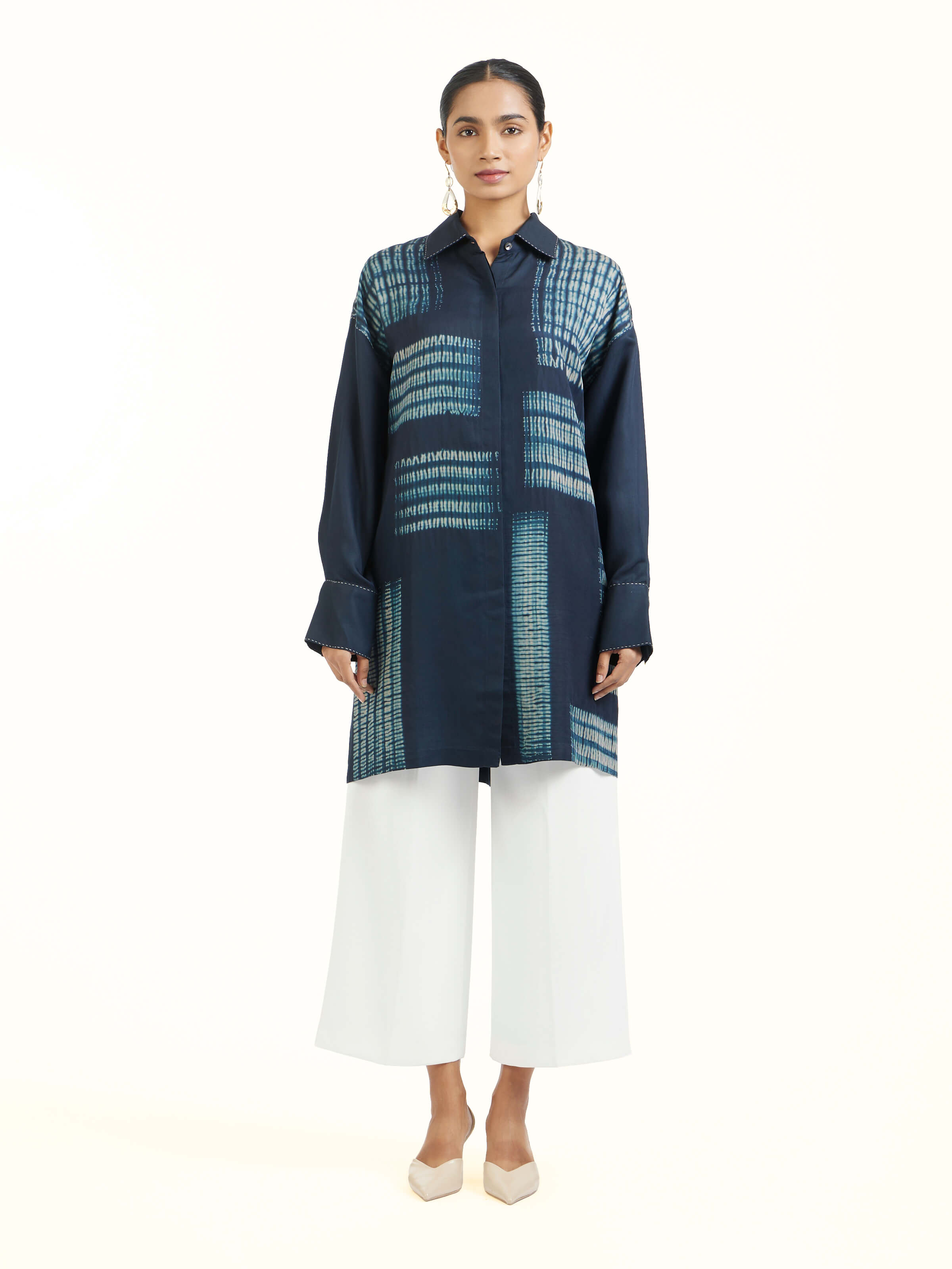 Front view of blue shibori long shirt with traditional resist-dye patterns