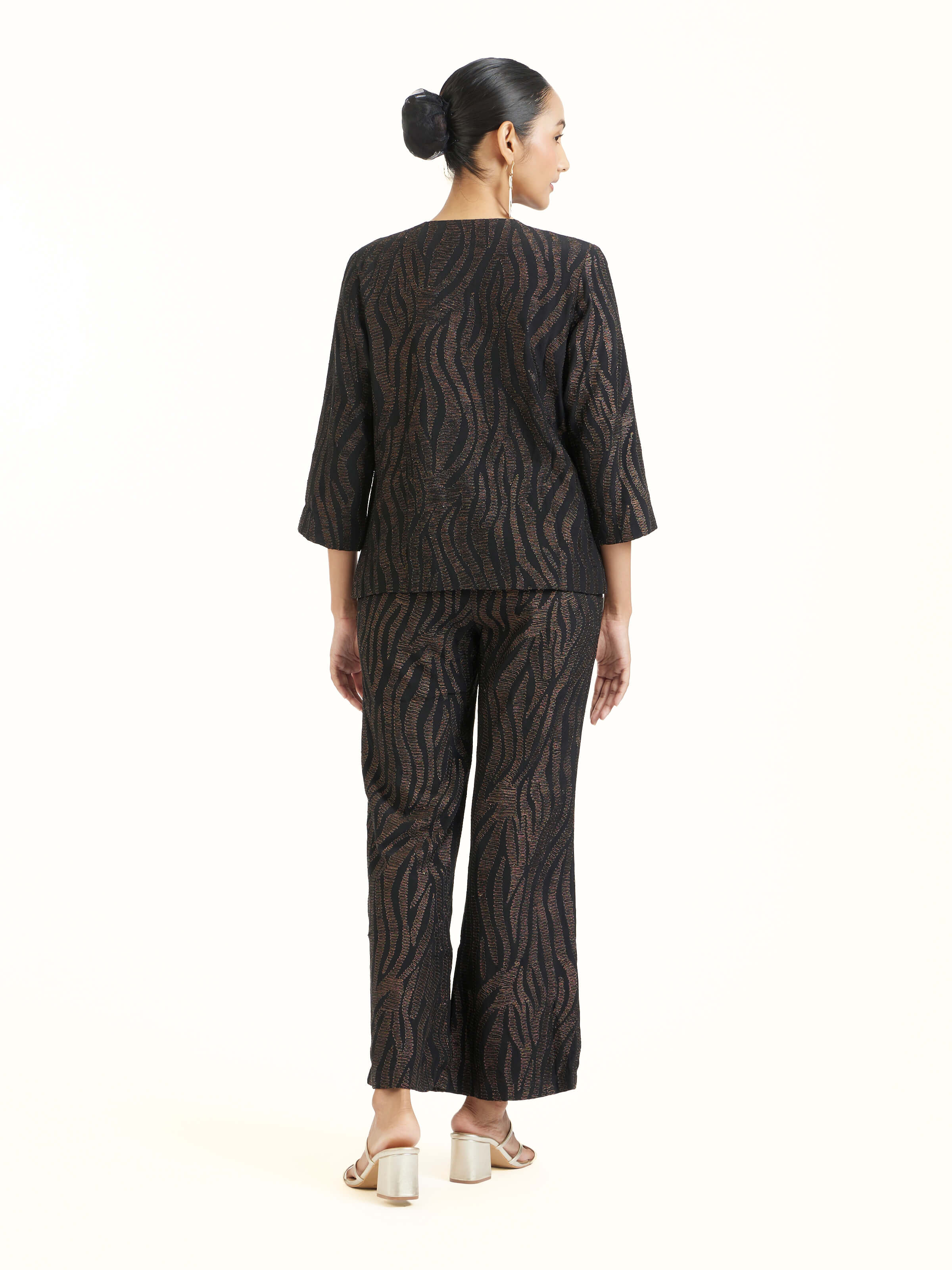 Back view of black Aari hand embroidered pants displaying overall design