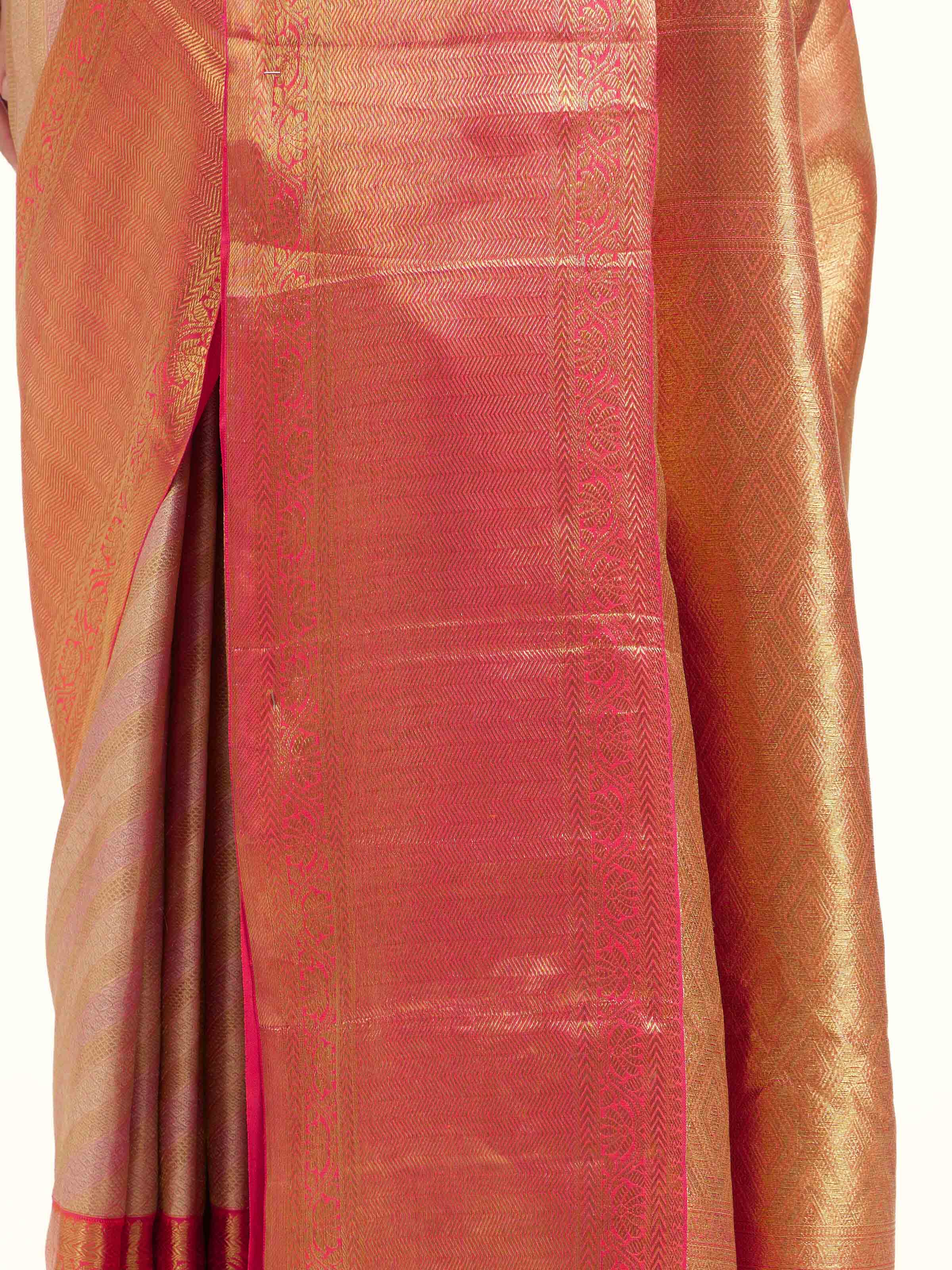 Detail view of light pink silk Kancheepuram saree showing smooth silk texture and zari craftsmanship