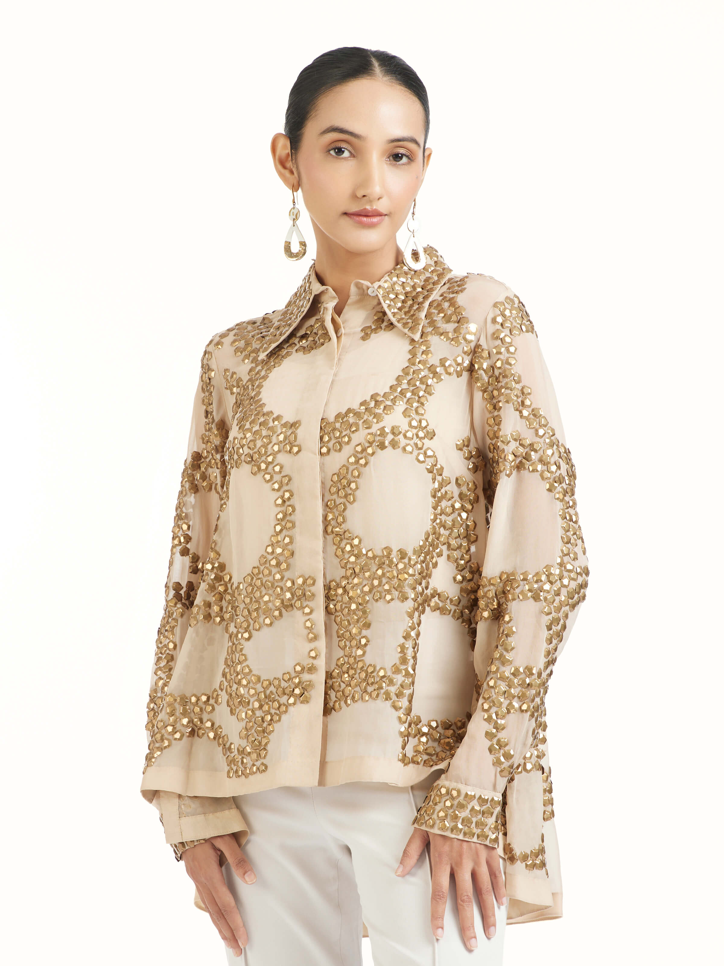 Angled view of beige hand embroidered organza gold shirt highlighting embroidery