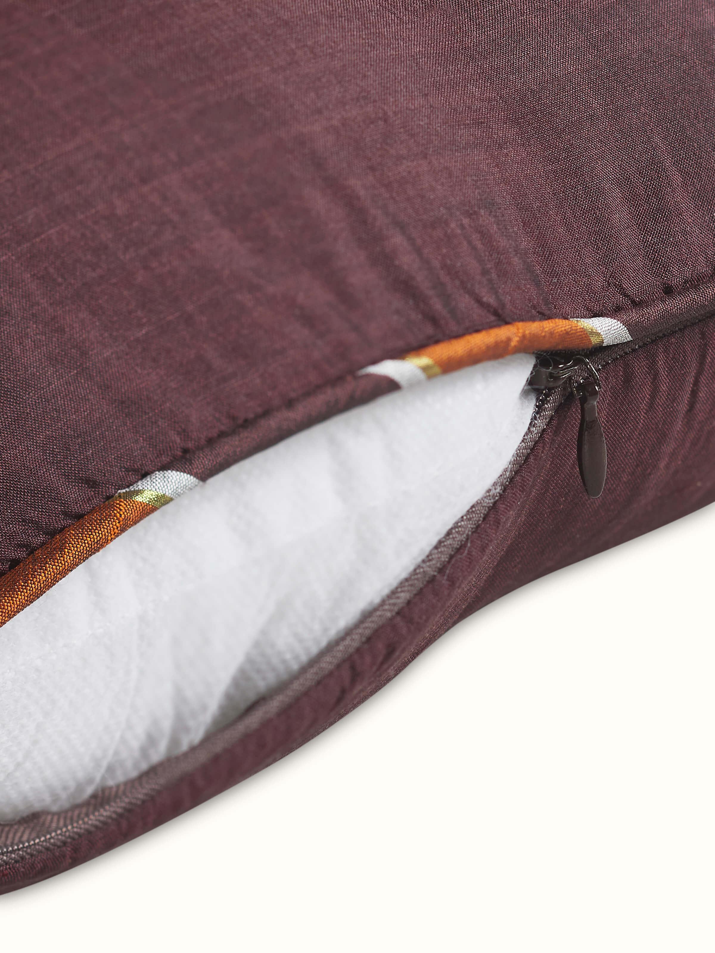 Close-up of handcrafted cushion cover highlighting subtle silk sheen and craftsmanship.