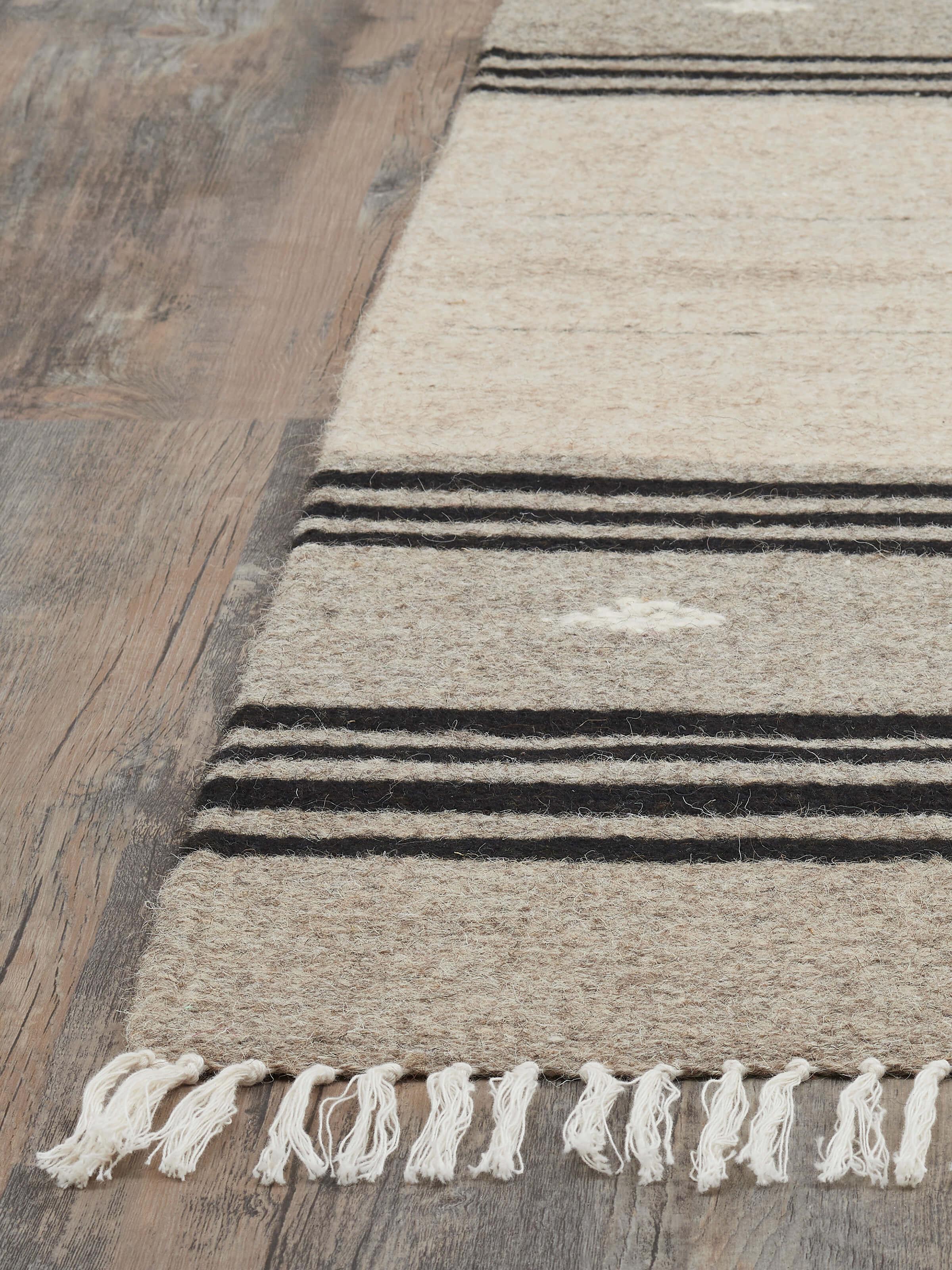 Detailed view of Nomad stripes beige black Jawaja wool & cotton handloom dhurrie (3x5 ft) focusing on the weave and color contrast