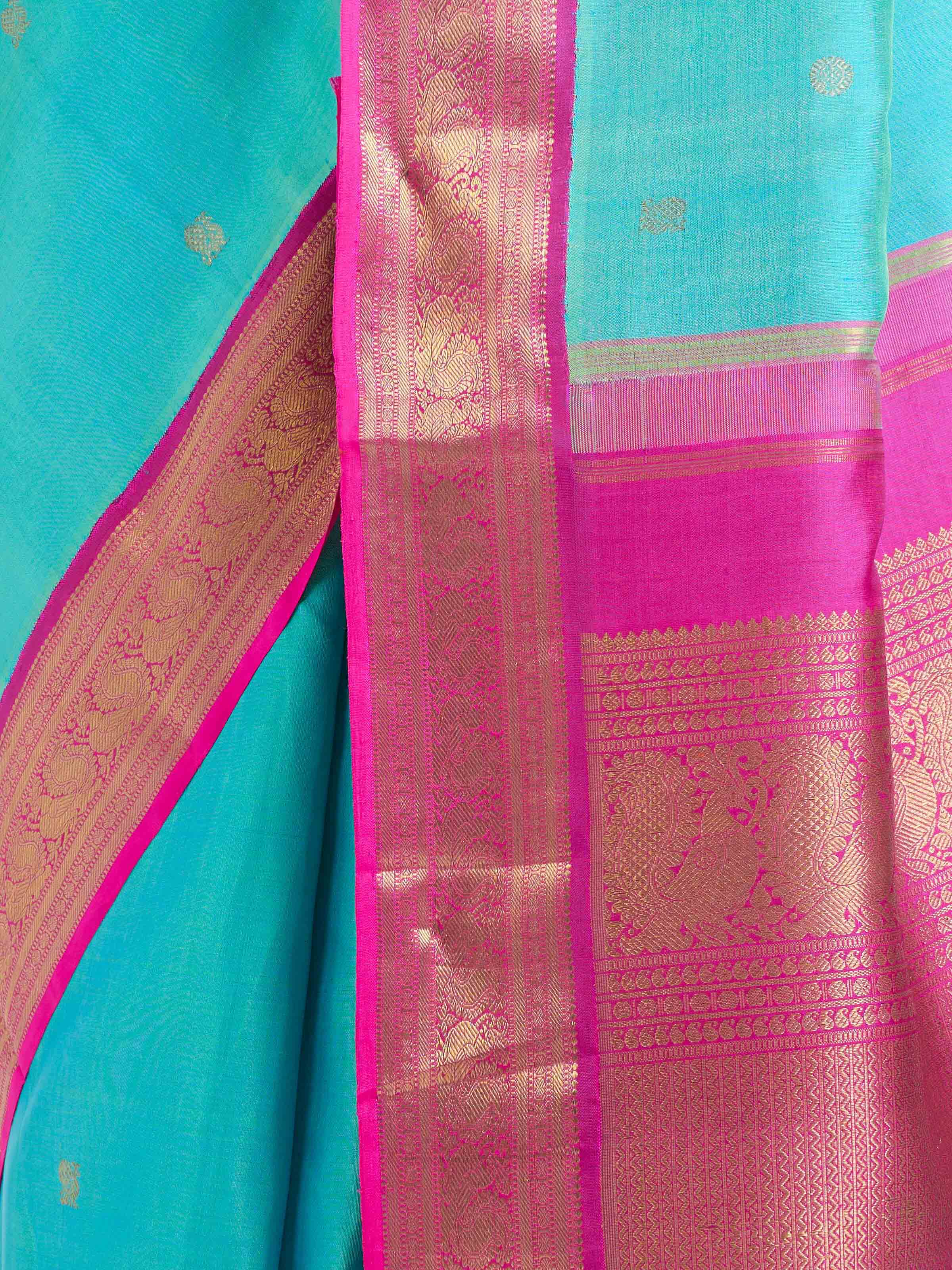 Detail view of turquoise silk Kancheepuram saree showcasing zari craftsmanship
