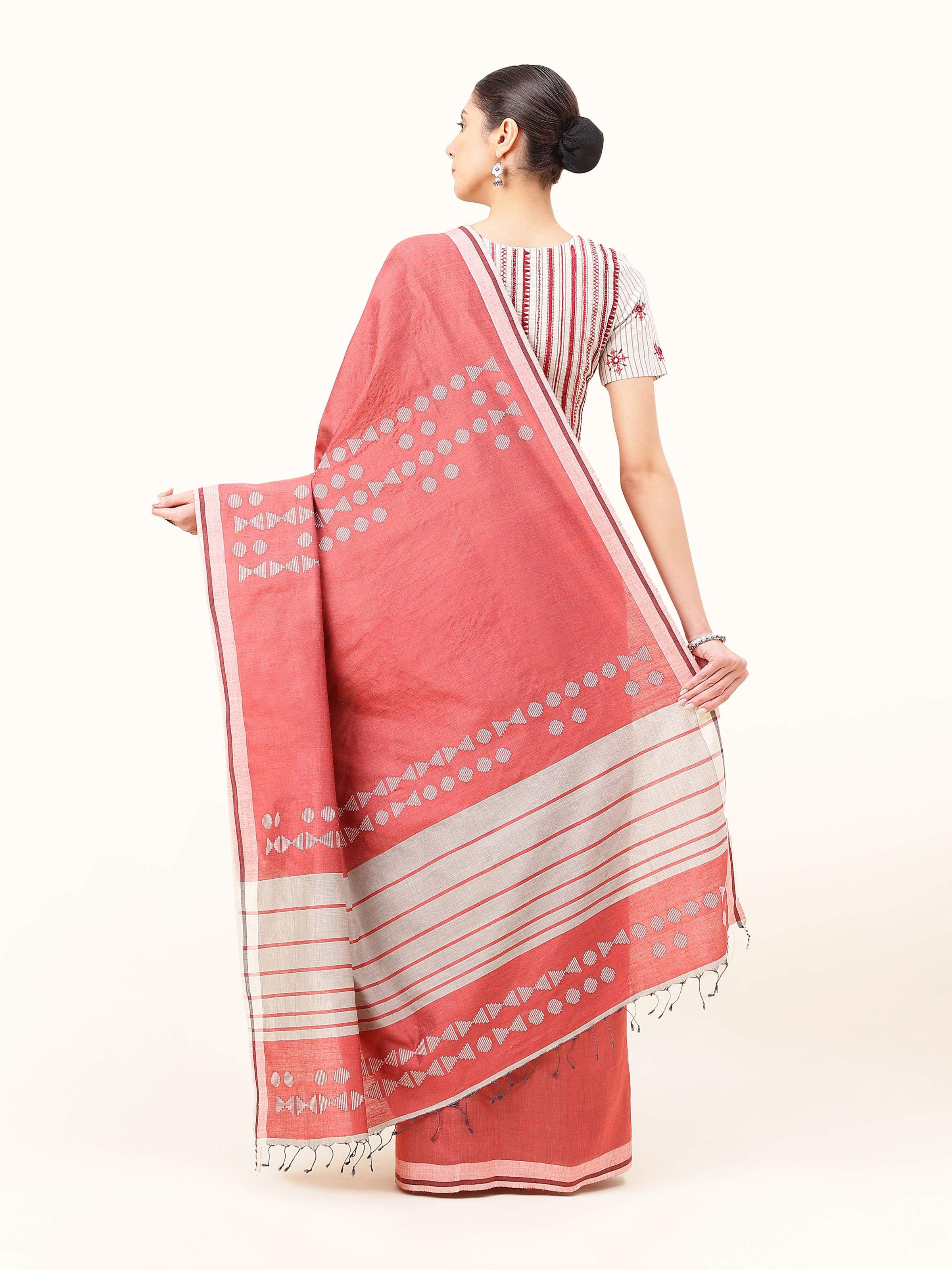 Back view of Maroon Silk Extra-weft Saree displaying pallu design and fabric flow.