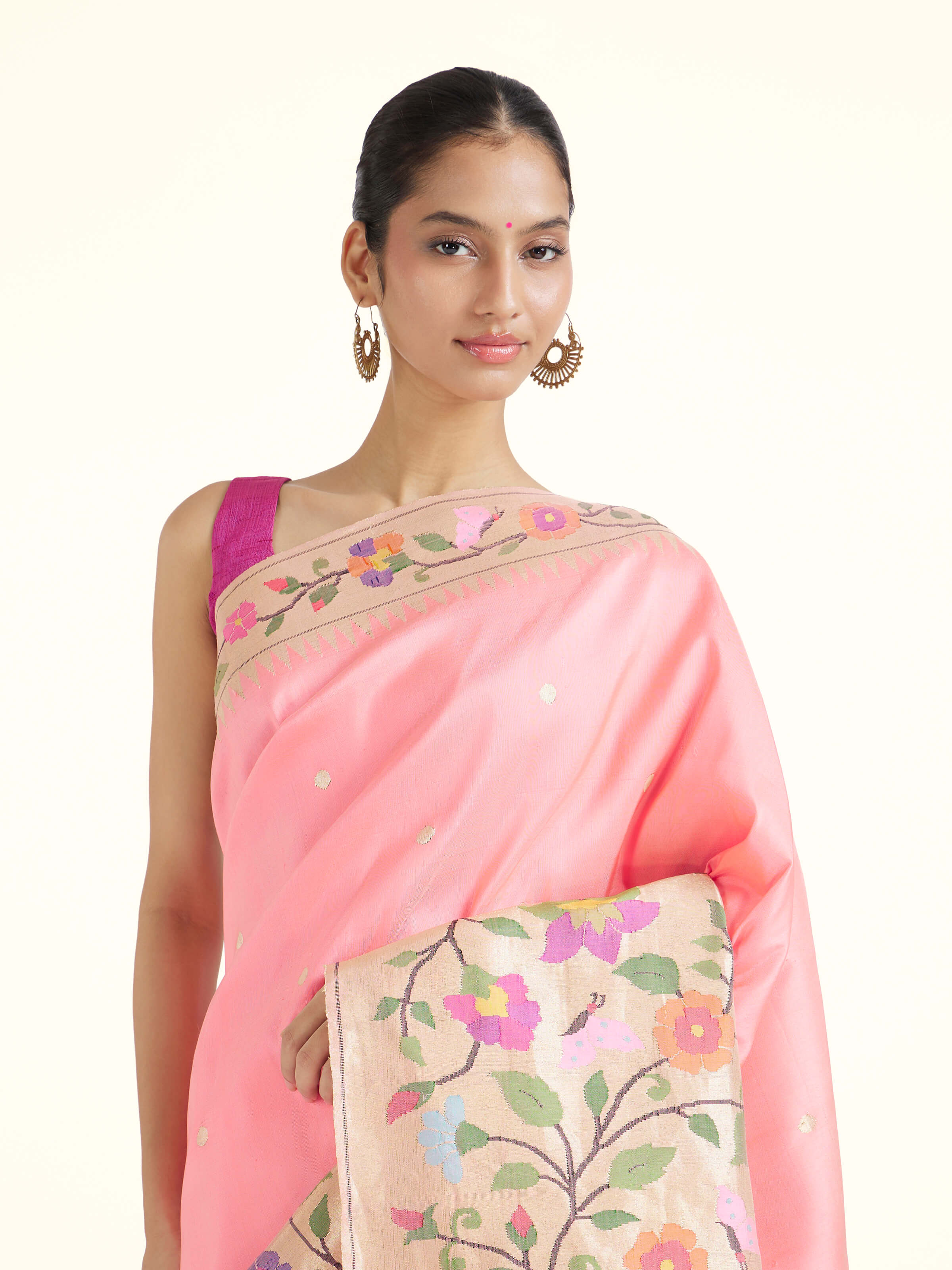 Angled view of pink silk Paithani saree highlighting intricate weave