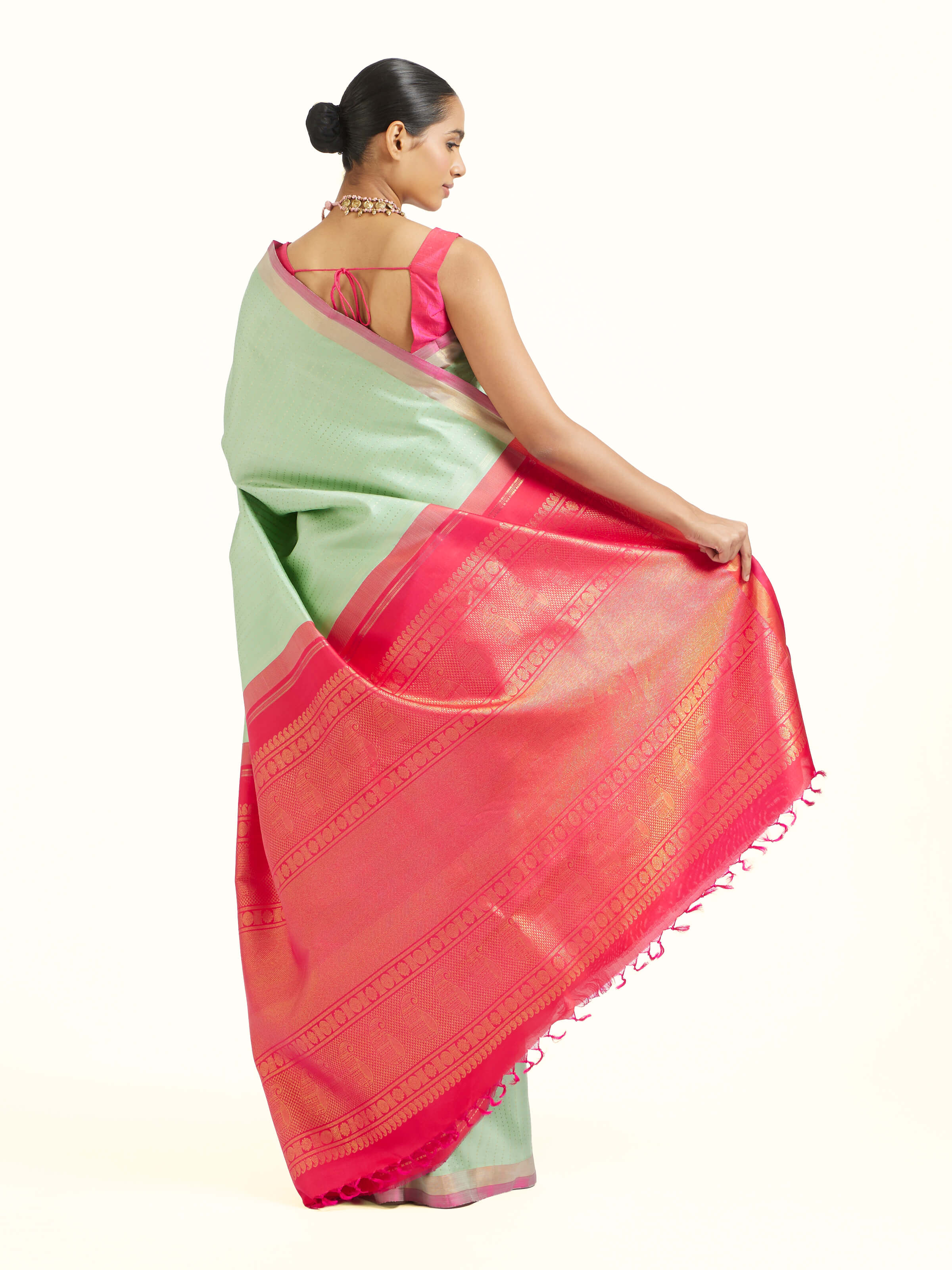 Back view of light green silk Kancheepuram saree displaying ornate pallu