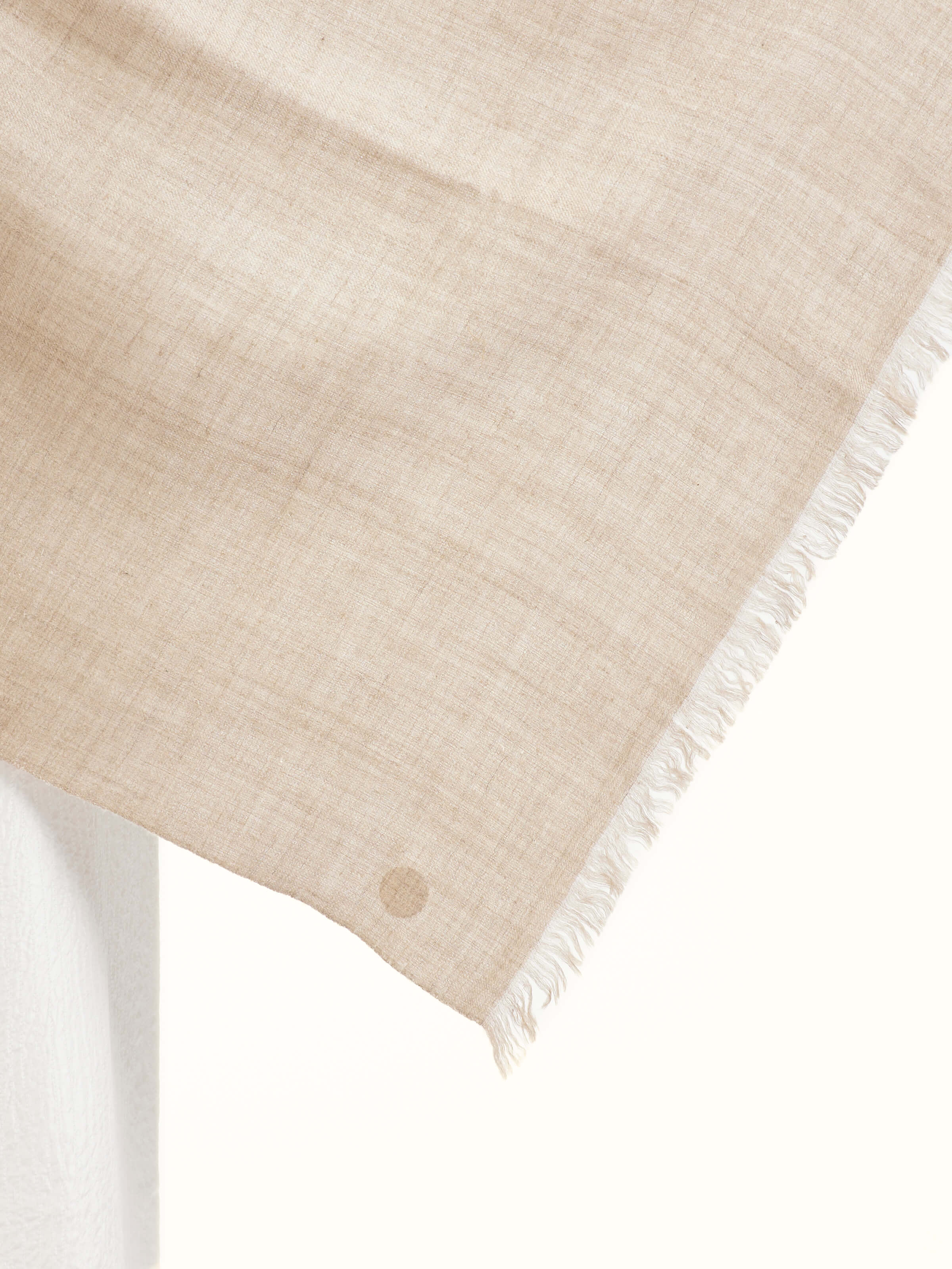 Detail view of beige cashmere stole showcasing craftsmanship