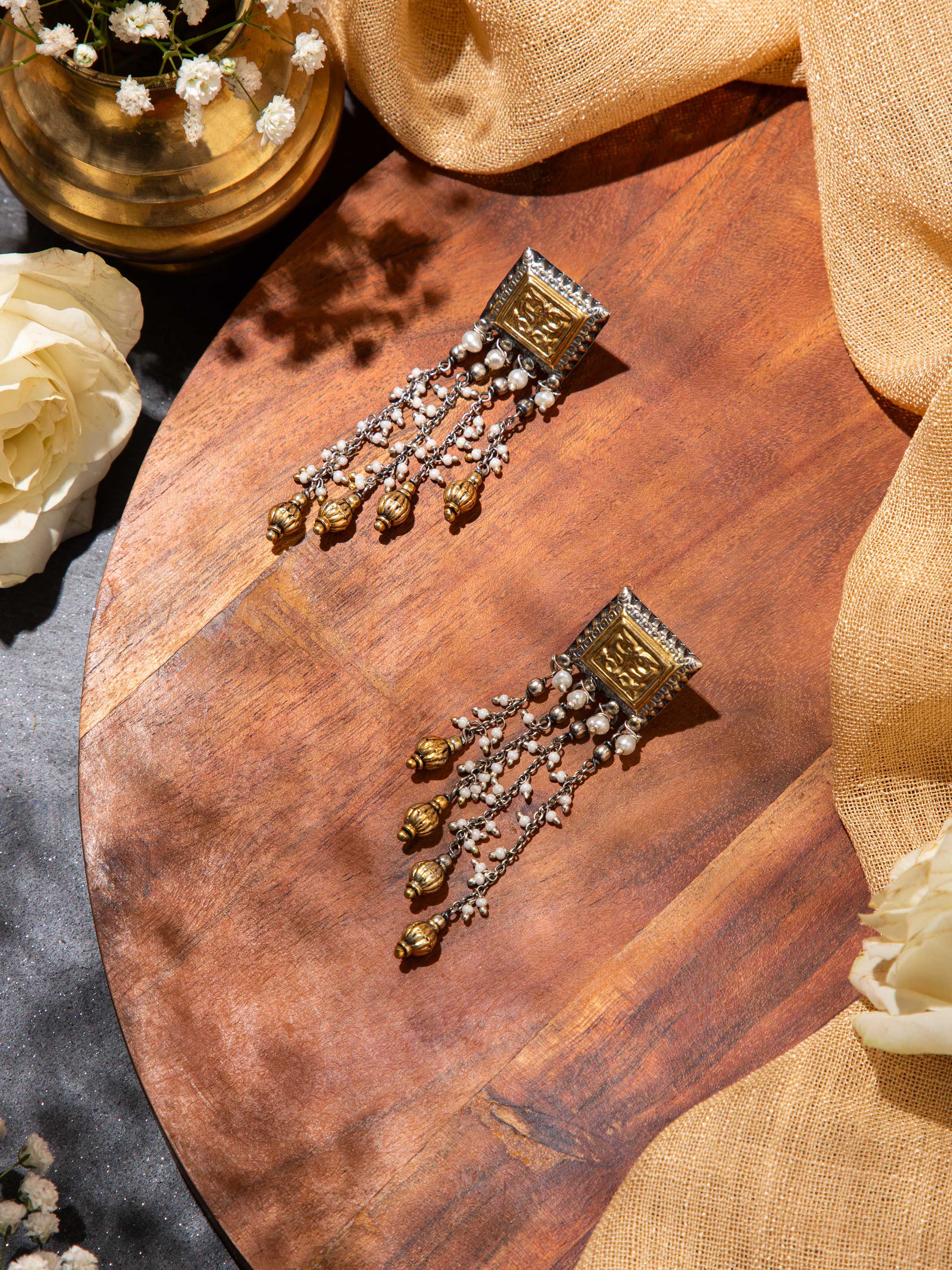 Lifestyle view of silver smithing drop earrings