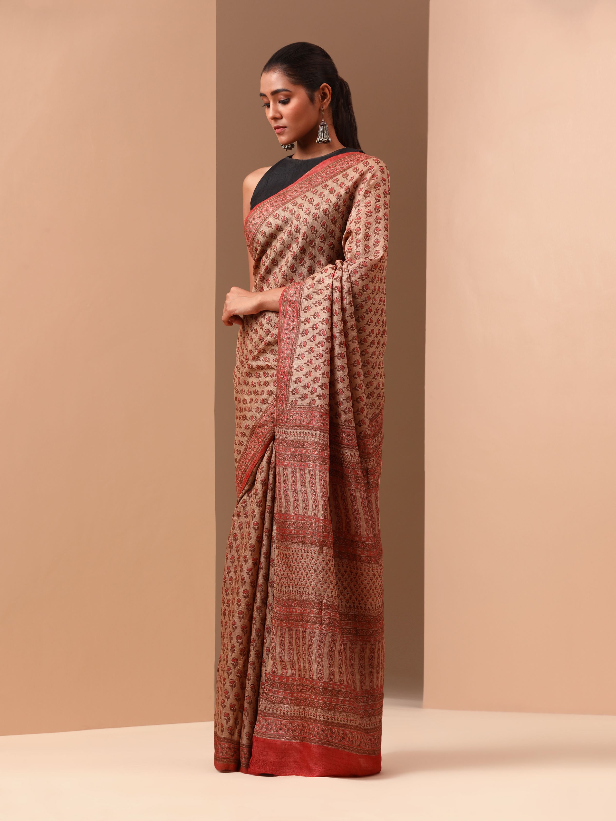 Angled view showing detailed block print designs on rich silk fabric