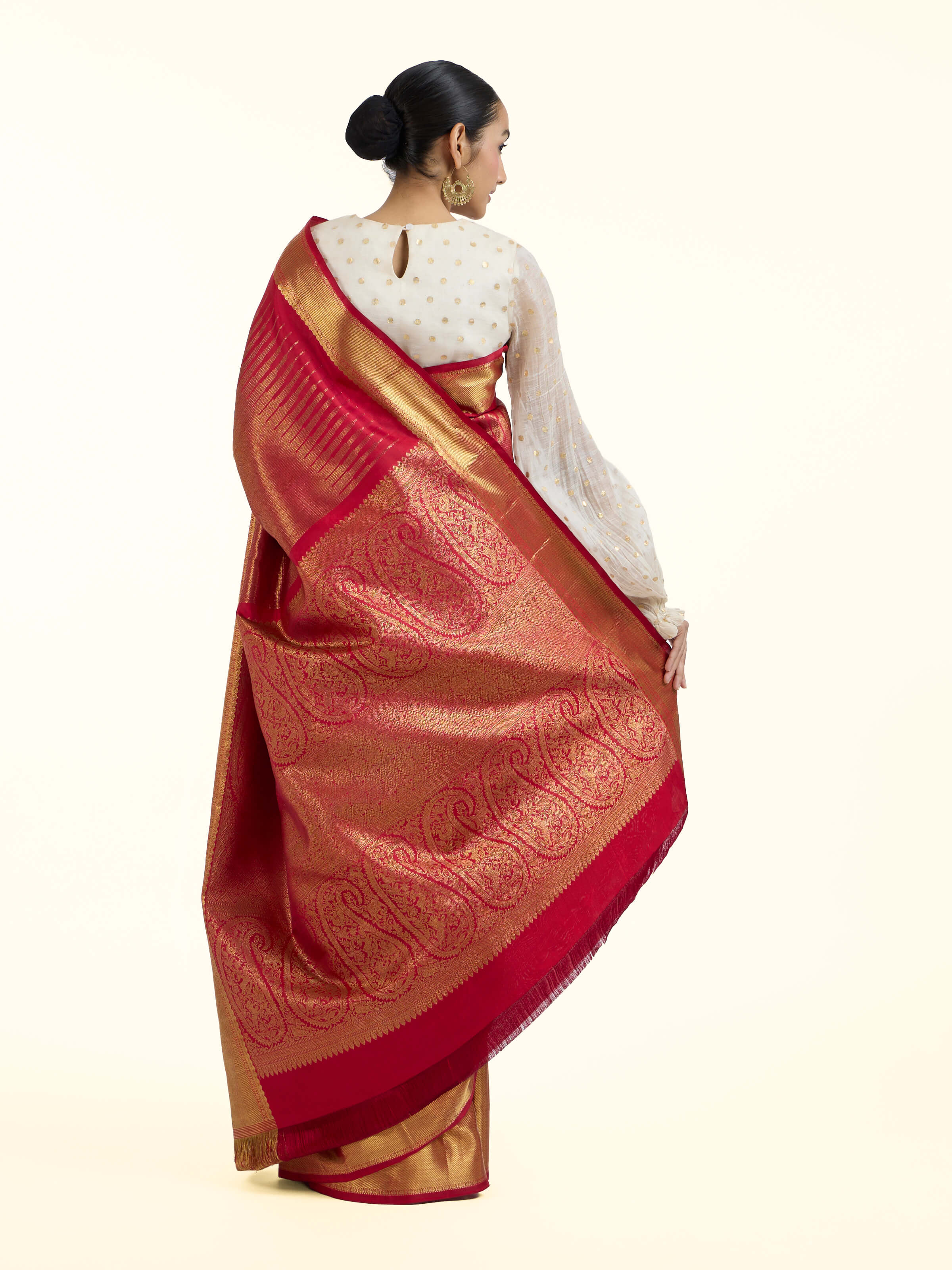Back view of red silk Kancheepuram saree displaying ornate pallu design