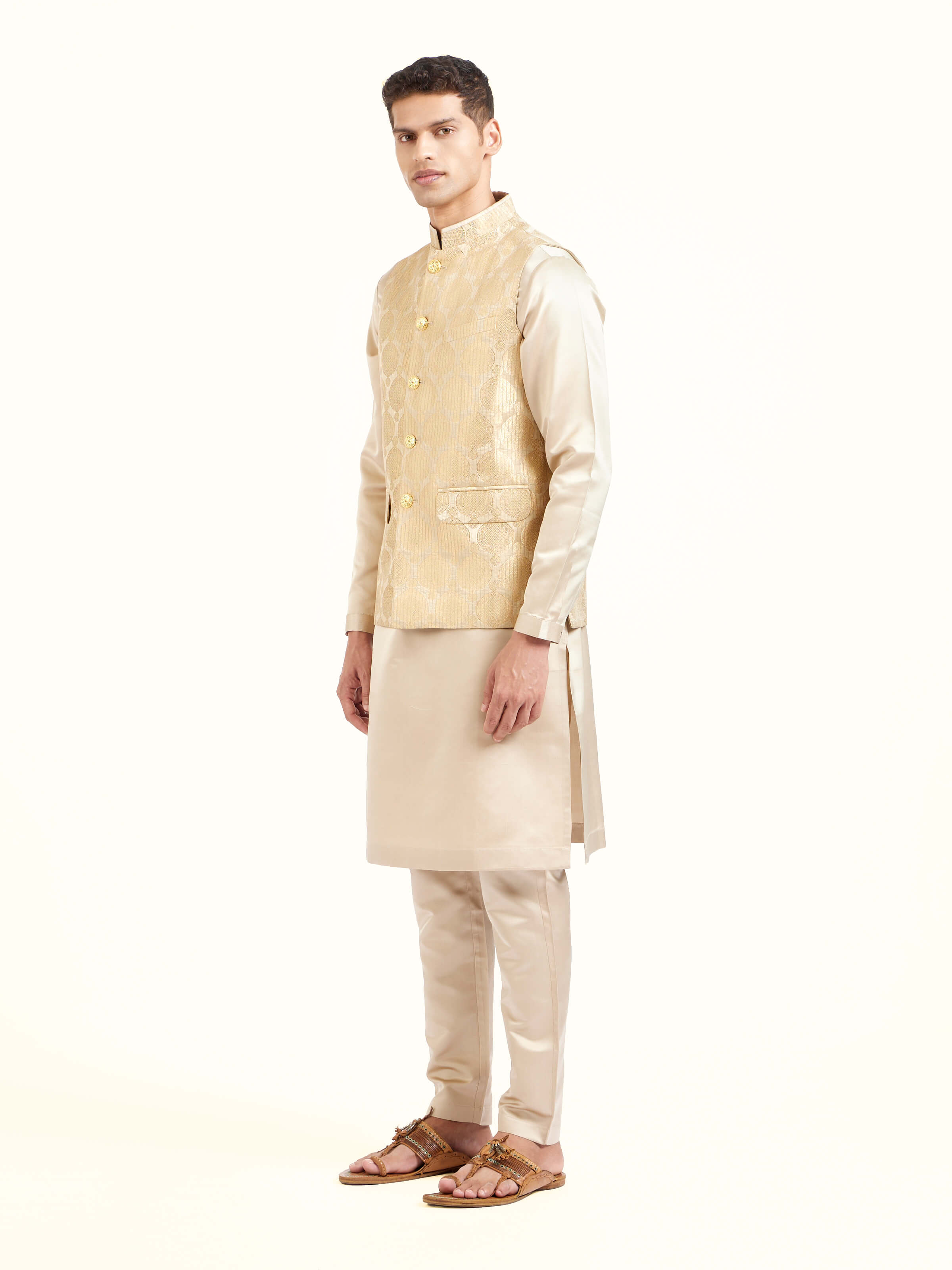 Side view of beige silk Banarasi sleeveless jacket highlighting tailored silhouette