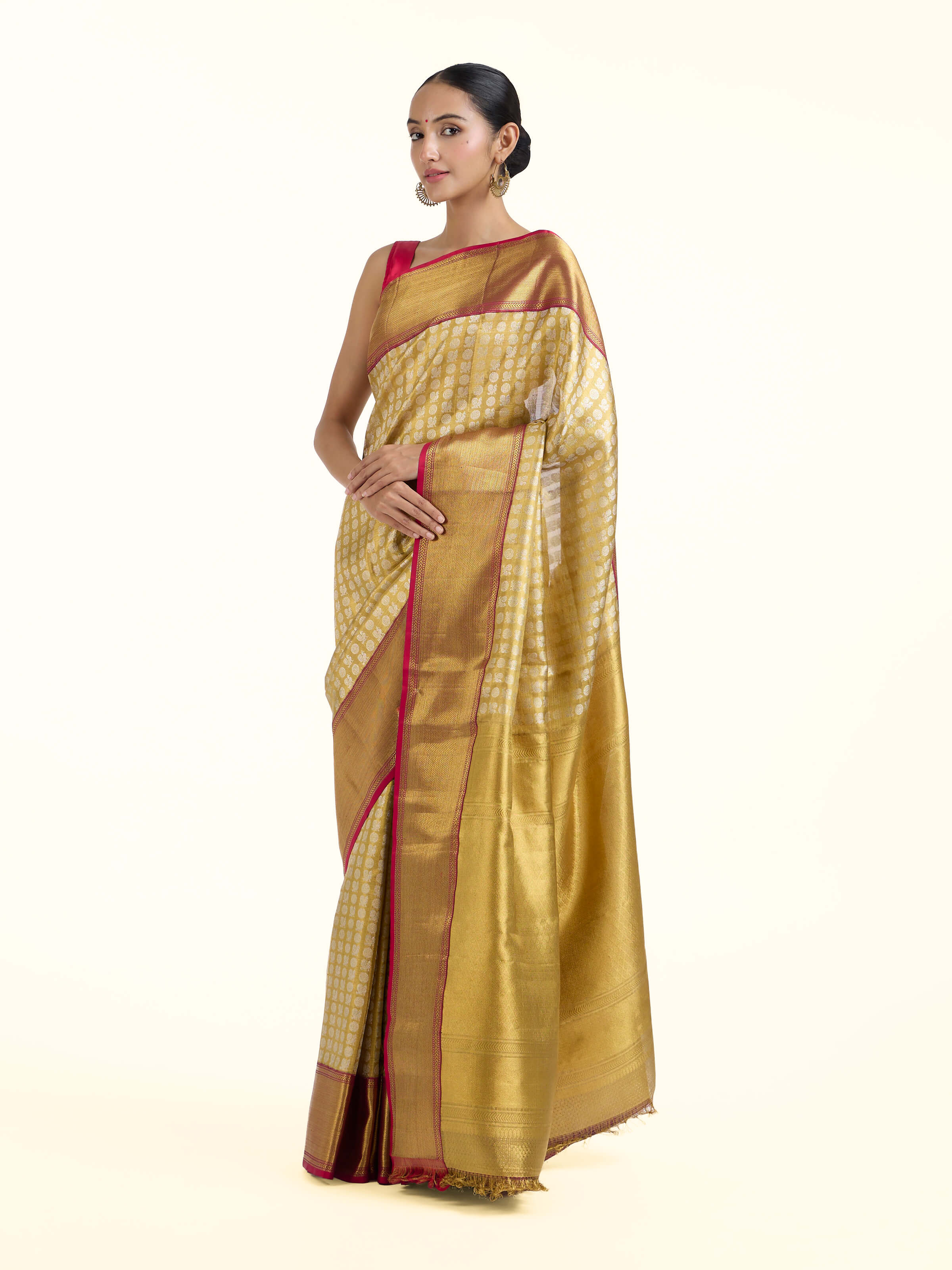 Side view of gold silk Kancheepuram saree with regal drape and traditional border