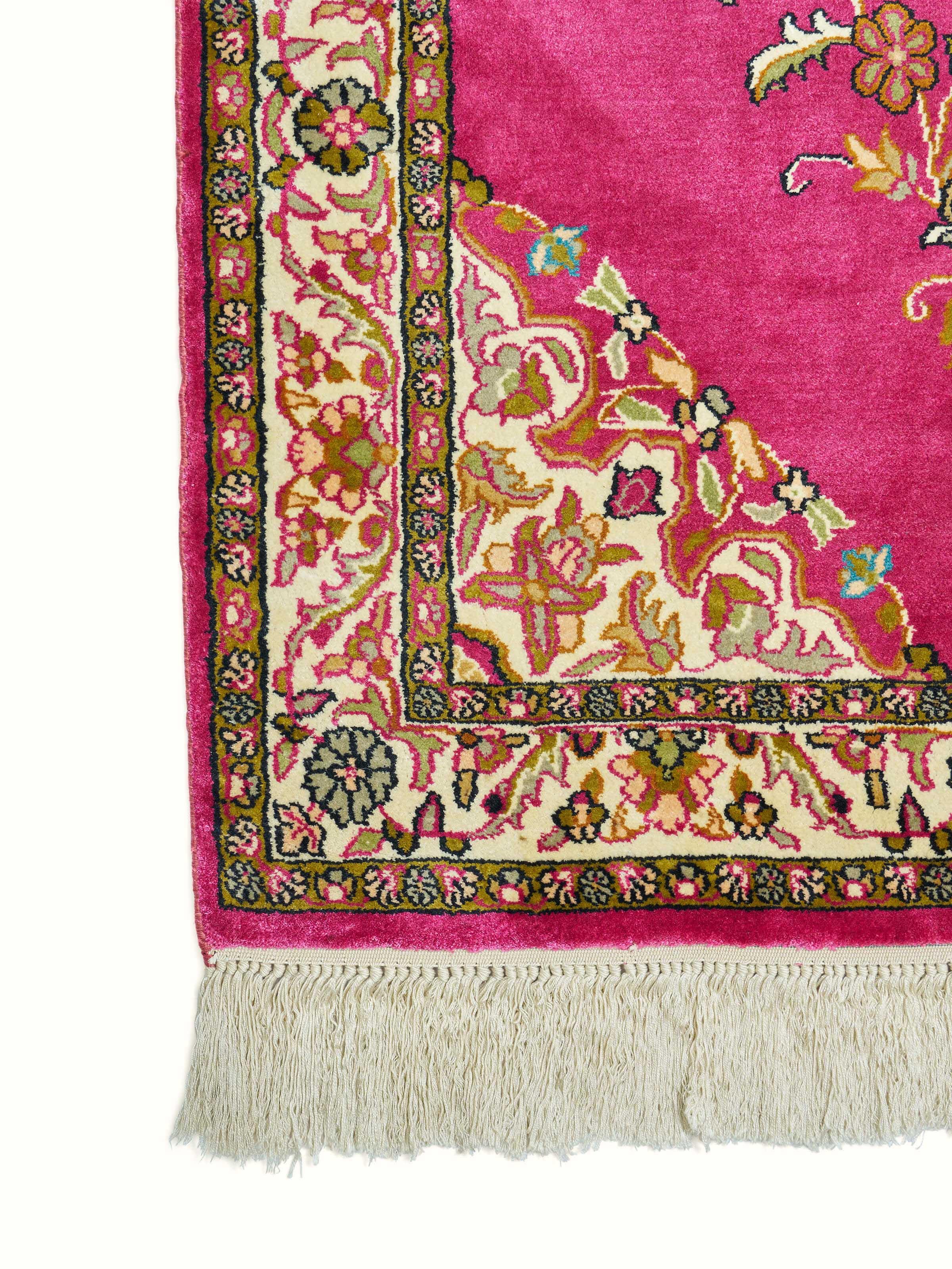 Detailed side view showing delicate pink shades and silk finish on Kashmir carpet