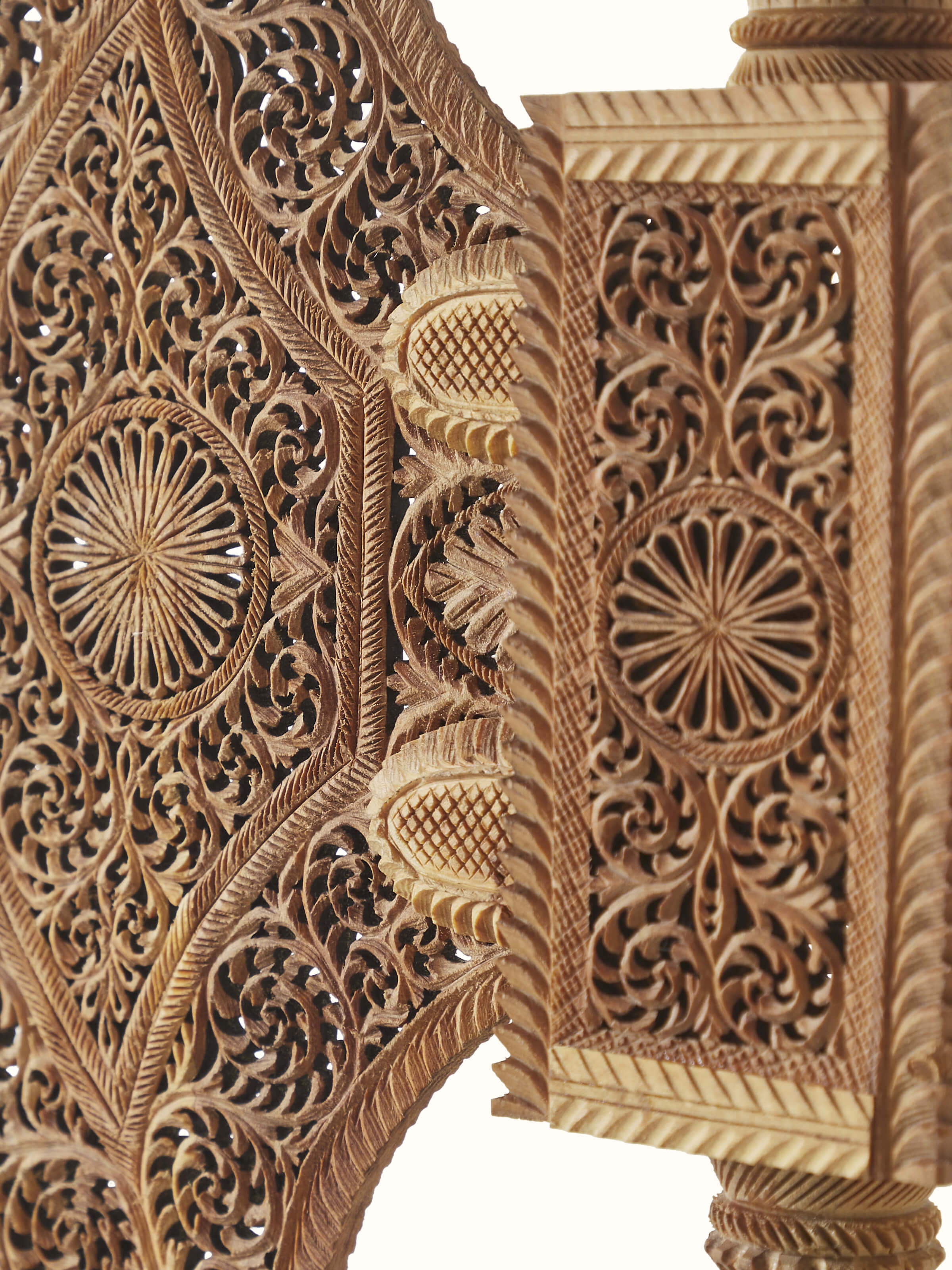 Side view of Bilara carved sandalwood jaali fan sculpture with focus on the jaali design