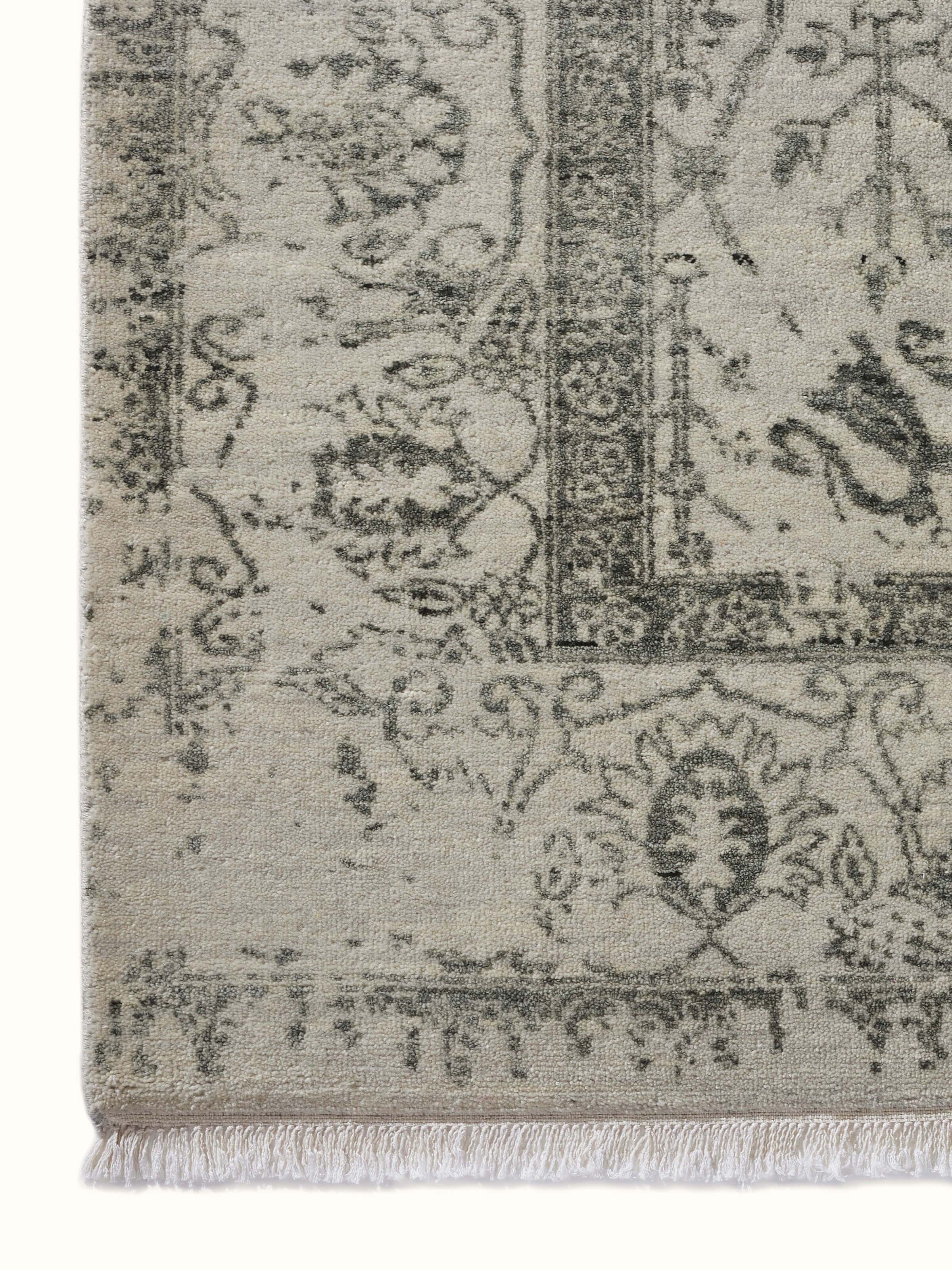 Detail shot of abstract pattern on grey hand-knotted Agra rug