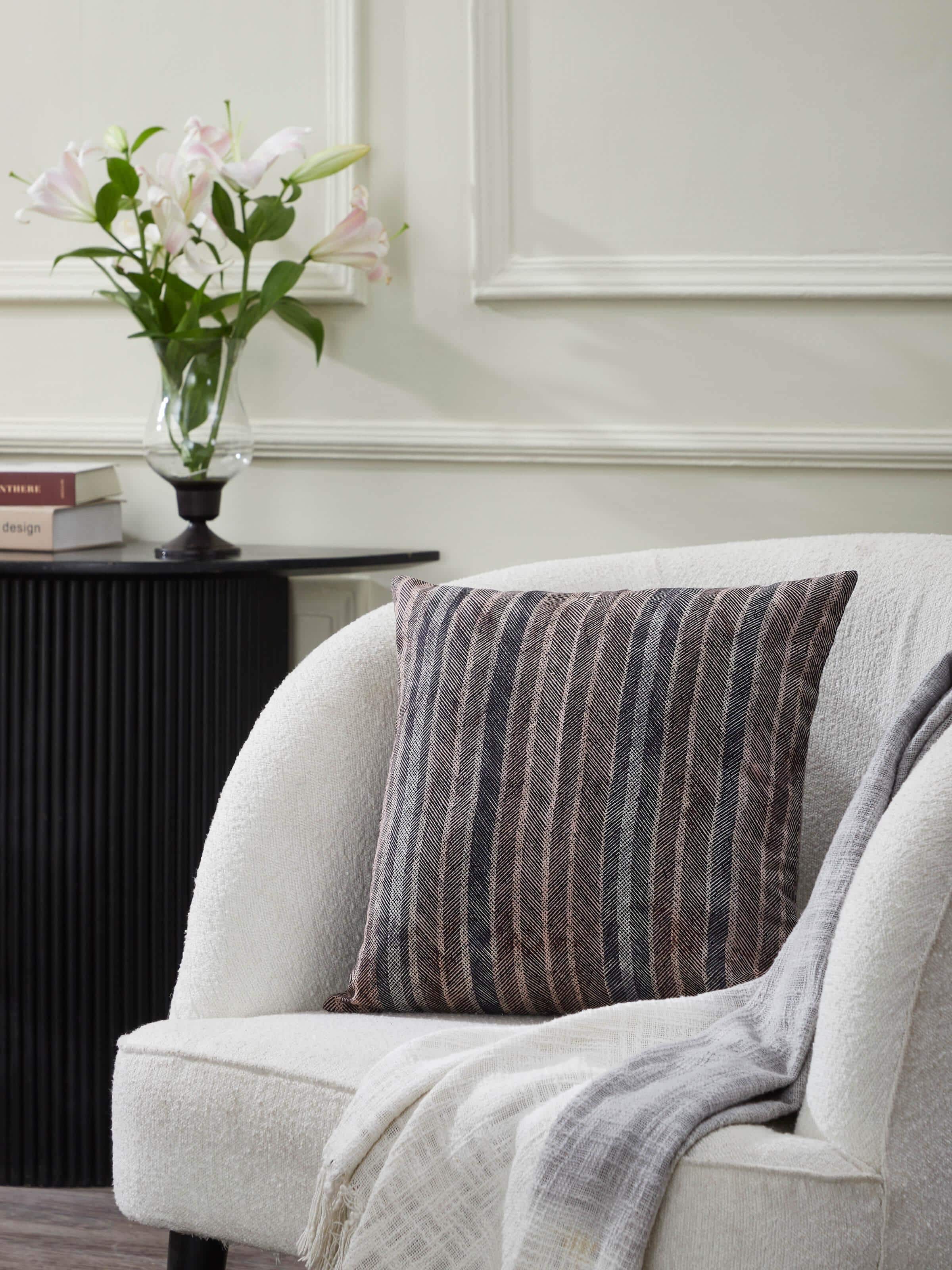 Sofa styling scene showing Parvat cushion cover adding earthy tones and texture.