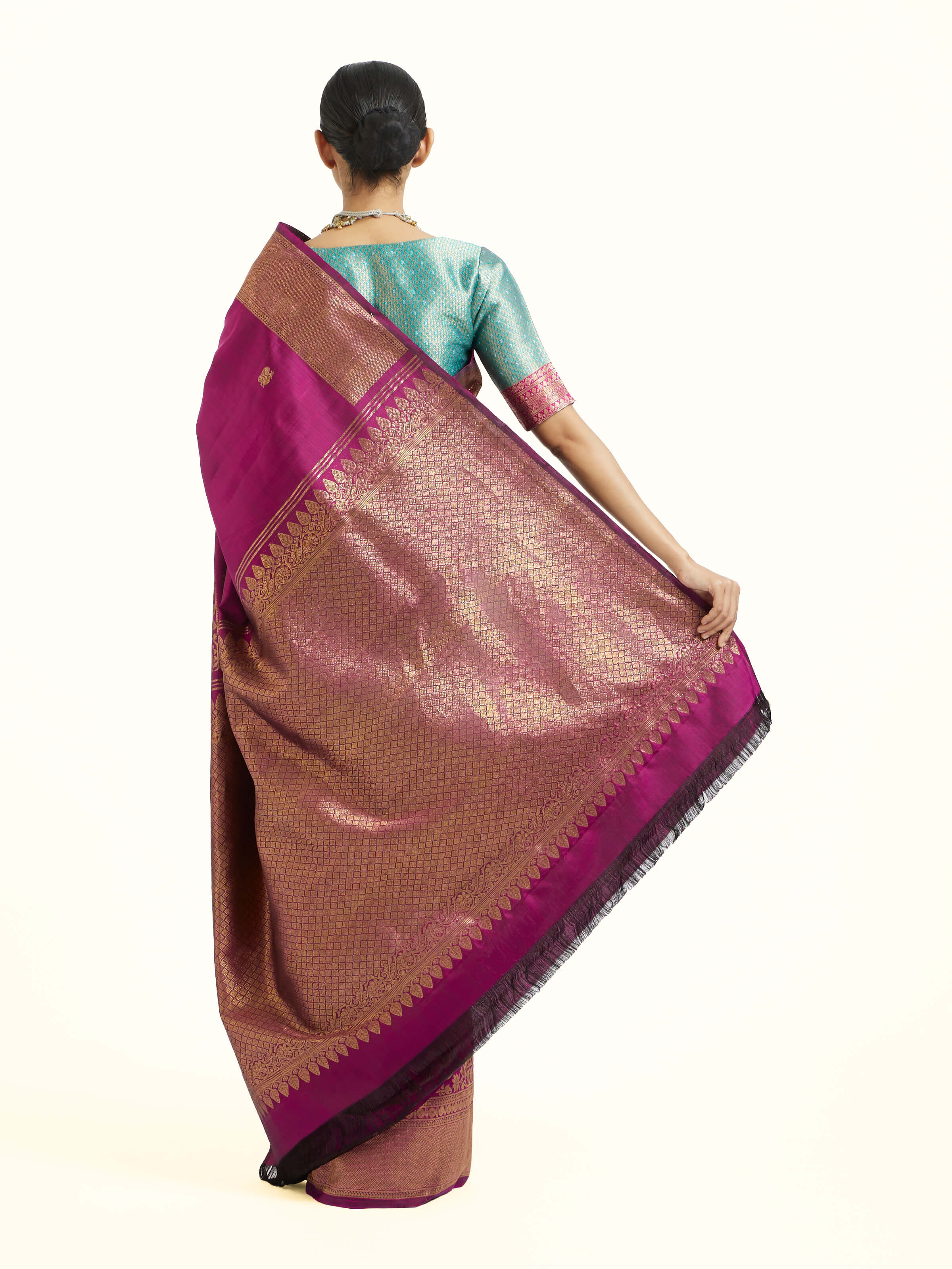 Back view of purple silk Kancheepuram saree displaying ornate pallu
