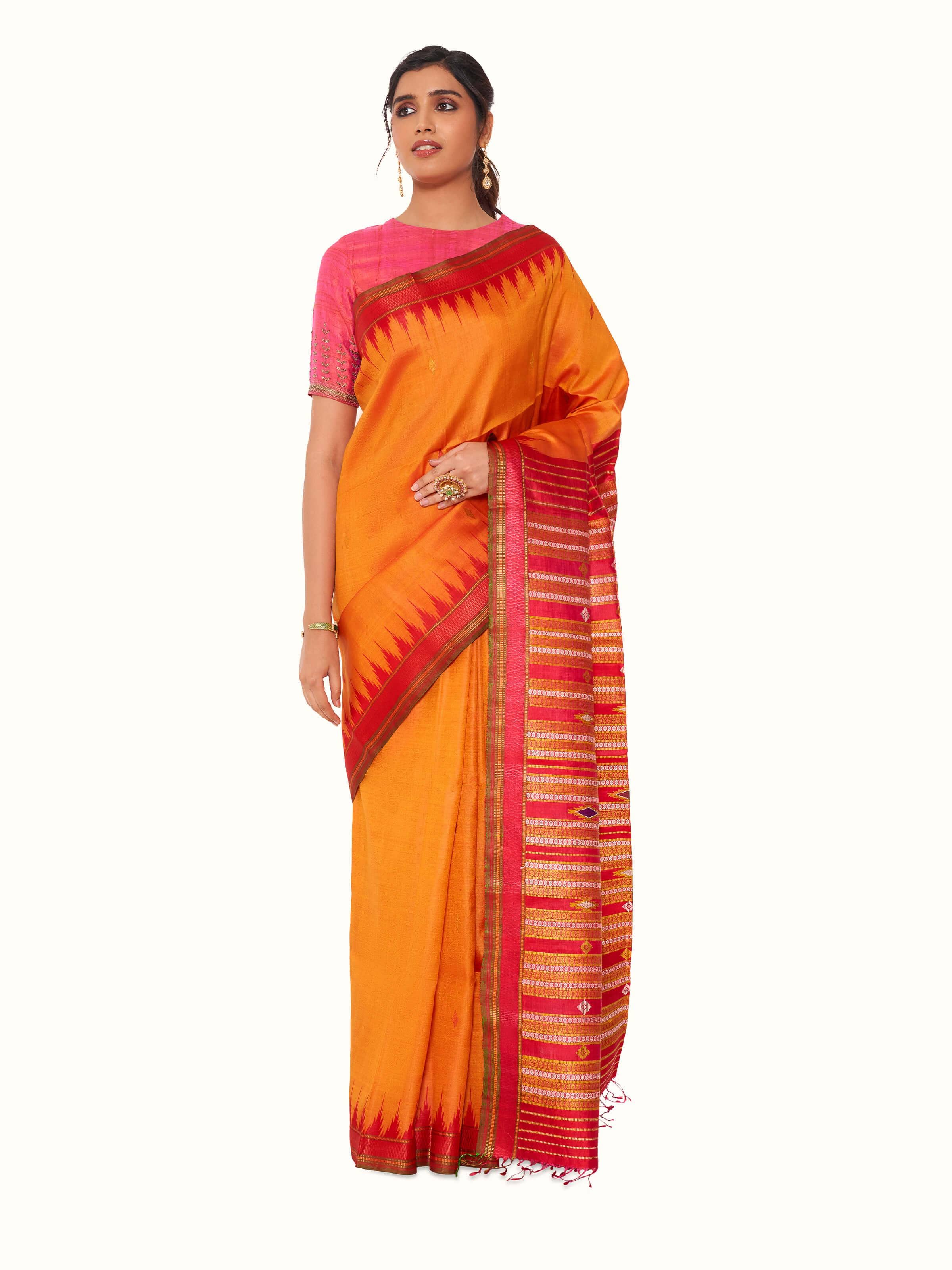 Front view of orange tussar silk bandha Odisha ikat saree showcasing traditional ikat patterns