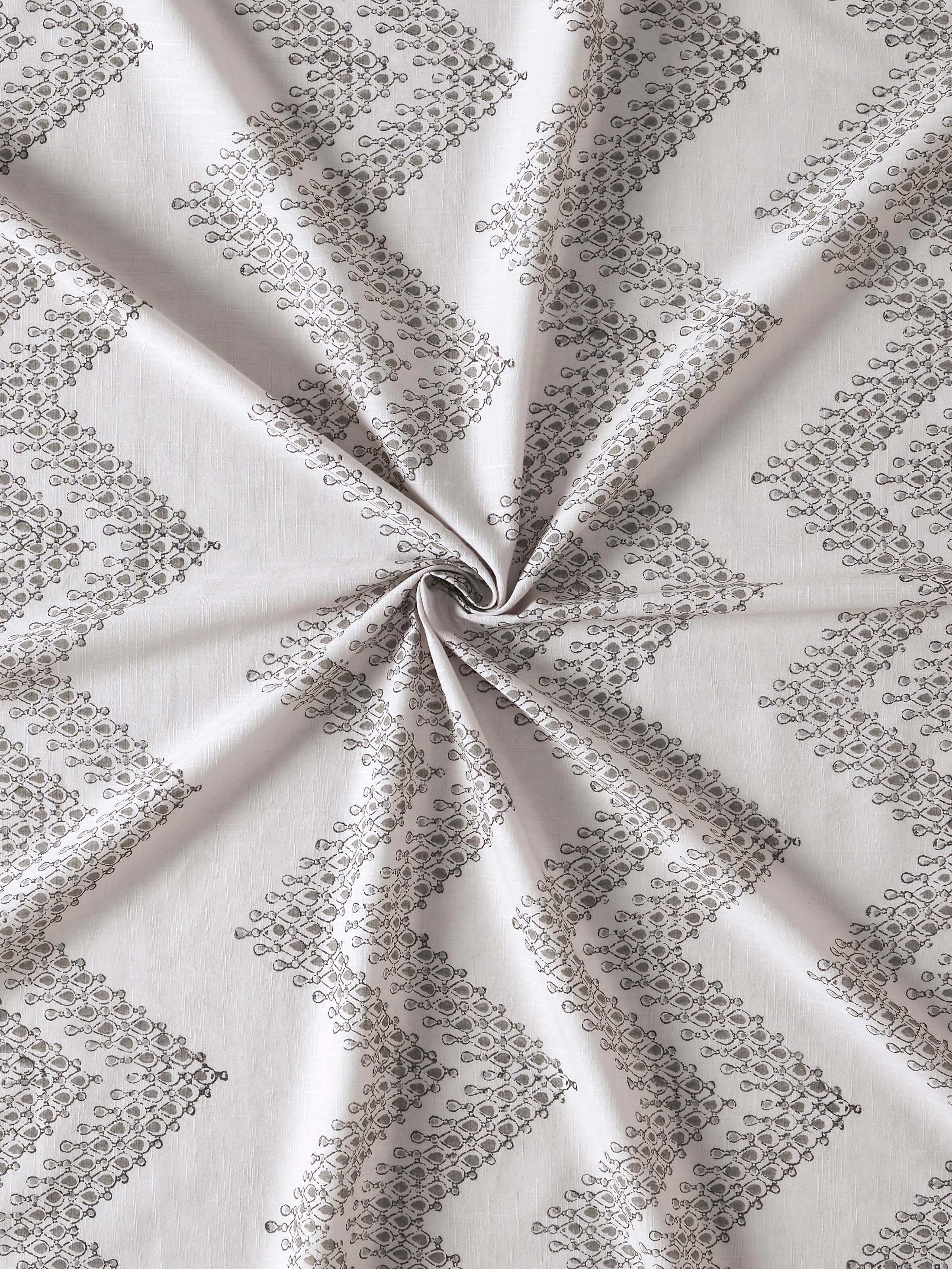 Close-up of geometric chevron block print on grey cotton curtain from Rambagh collection