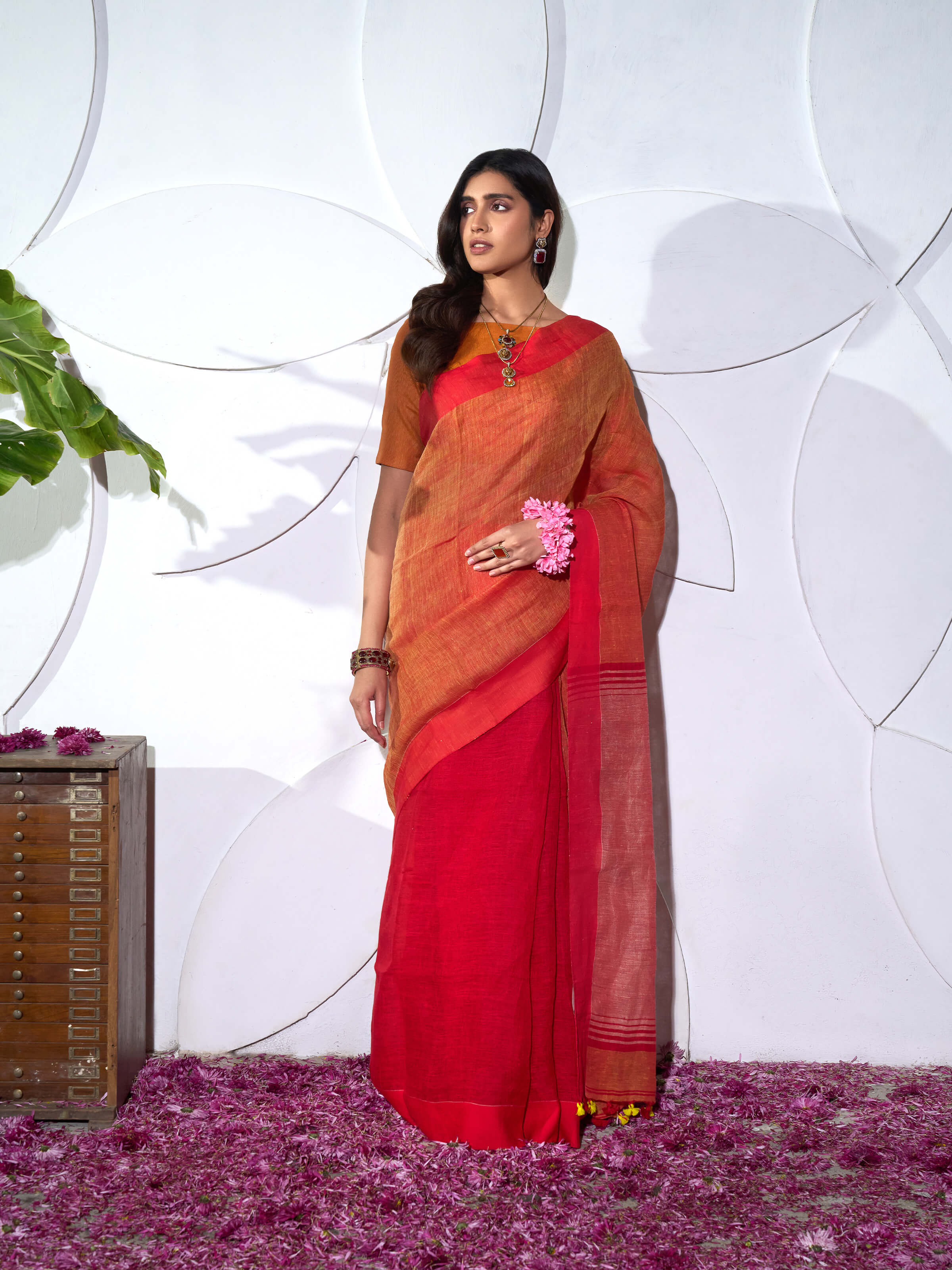 Side view of orange linen saree highlighting relaxed drape and airy feel
