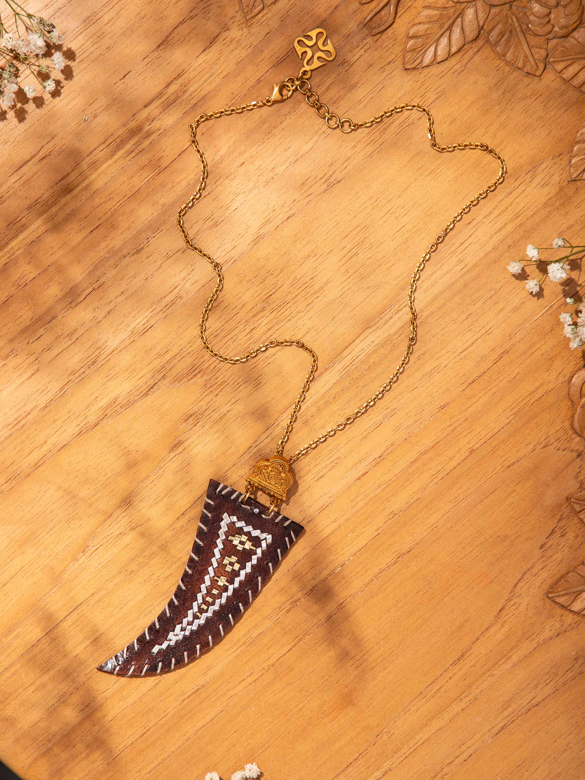 Lifestyle view of silver and leather pendant worn with traditional attire