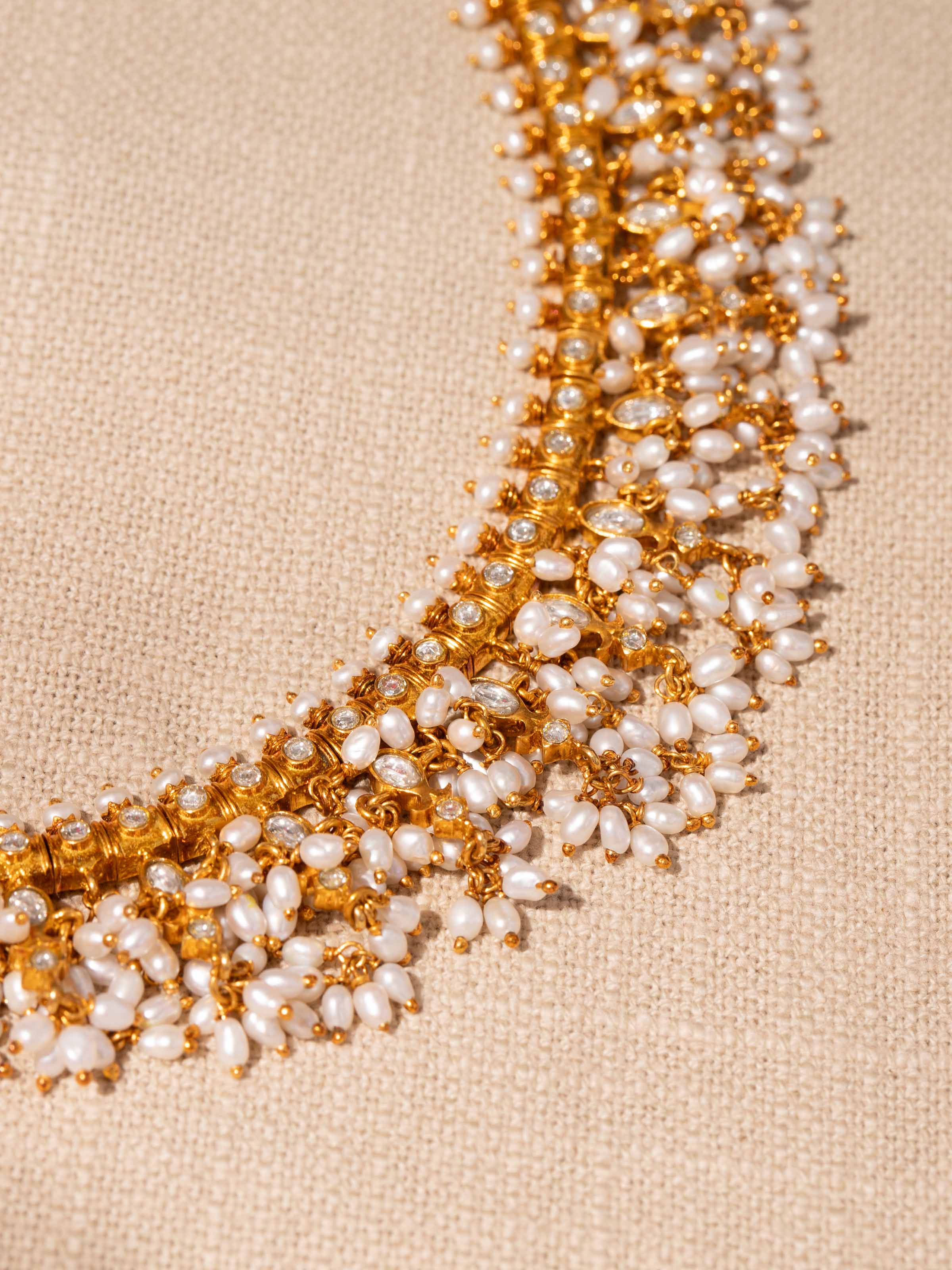 Detail shot highlighting pearl embellishments and textured silver craftsmanship.