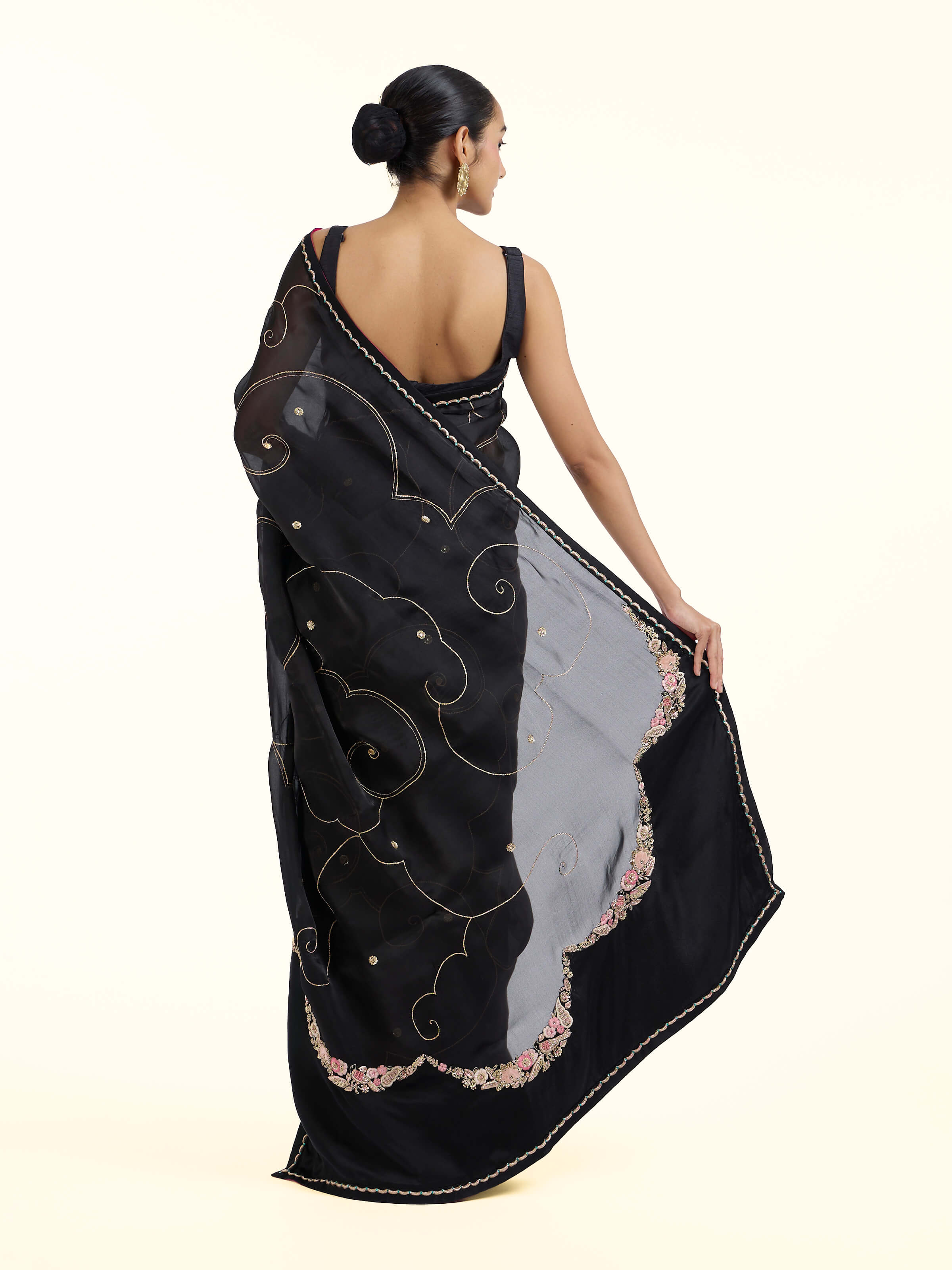 Back view of black silk zardozi saree displaying ornate pallu design
